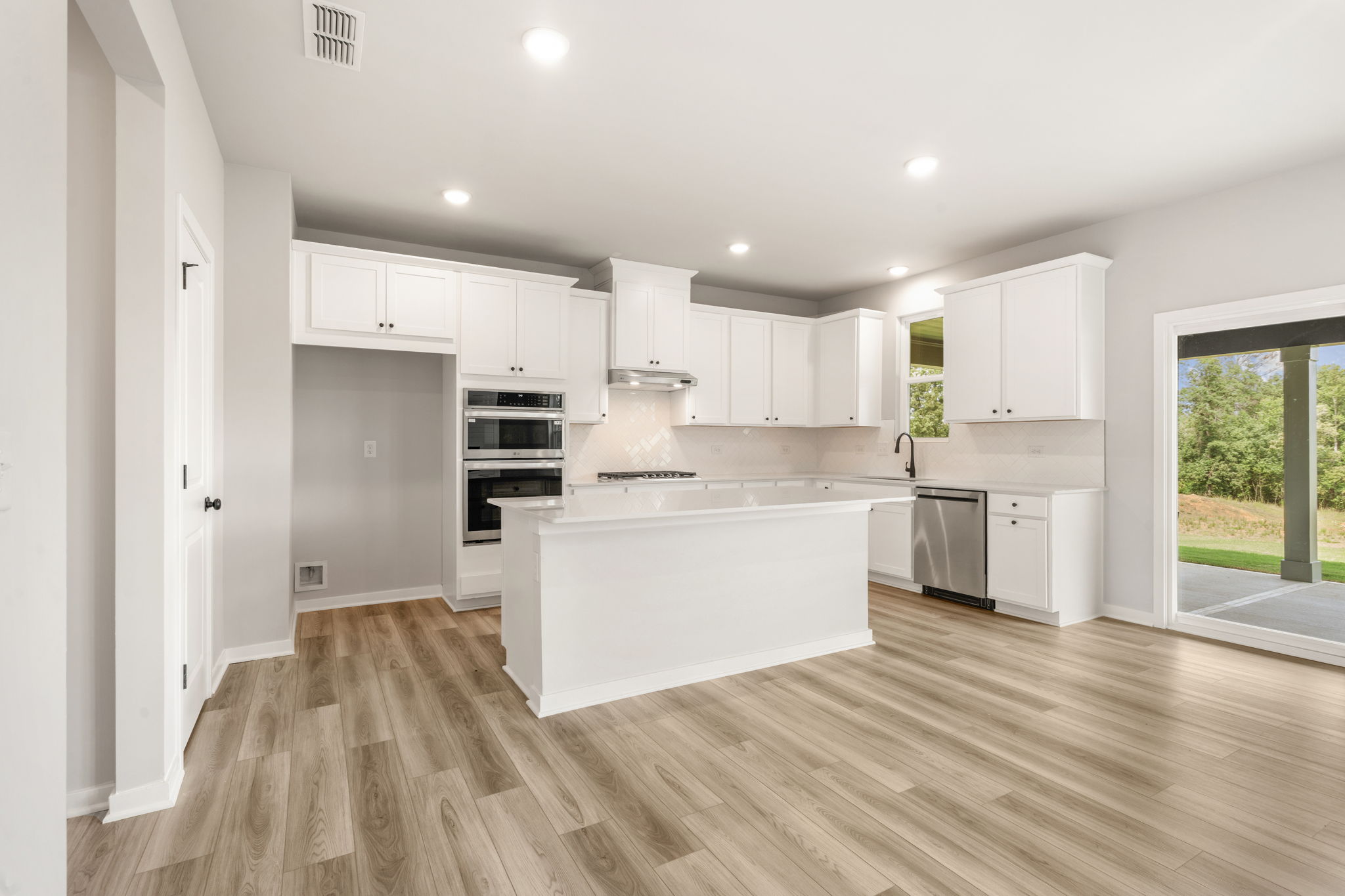 A kitchen with white cabinets.