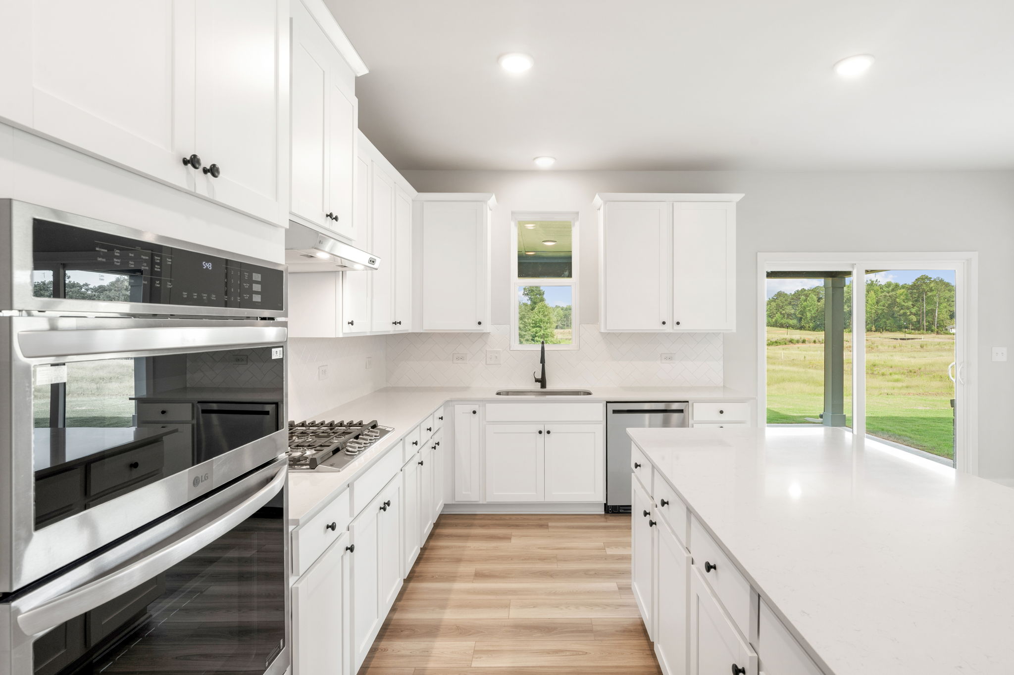 A kitchen with white cabinets.