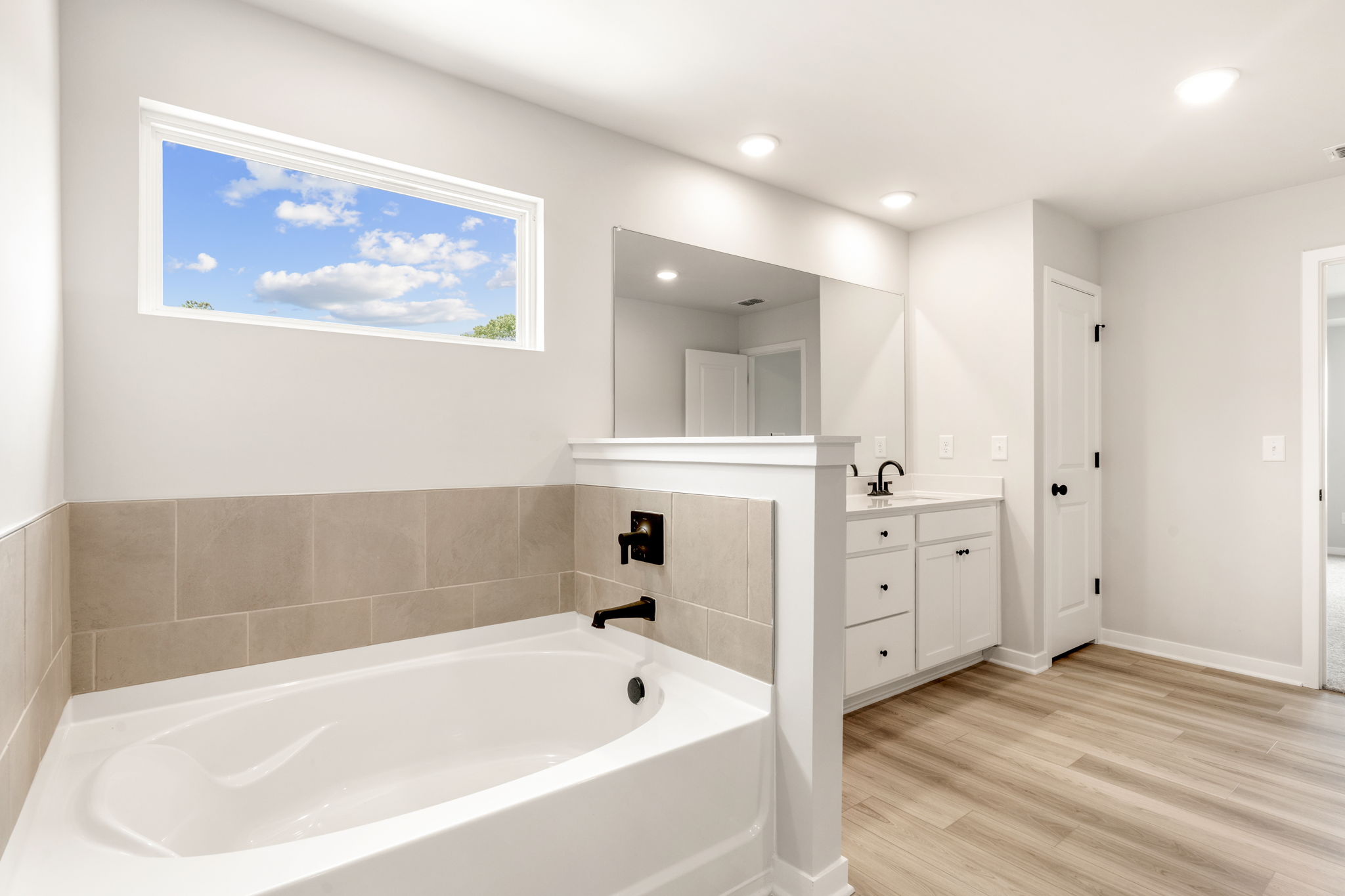 A bathroom with a large tub.