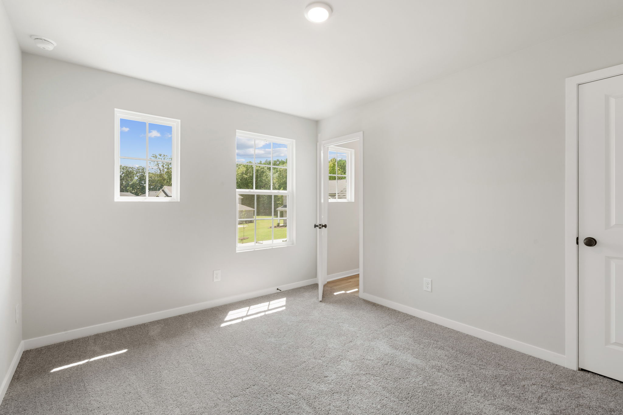 A room with white walls and windows.