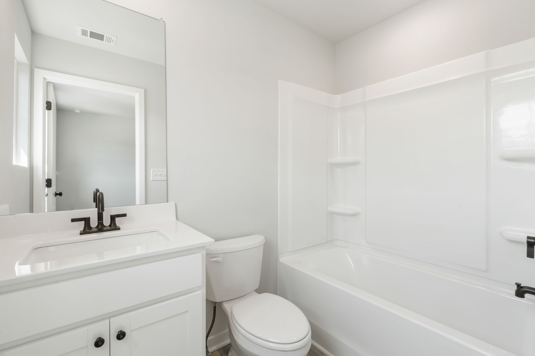 A bathroom with a tub toilet and sink.