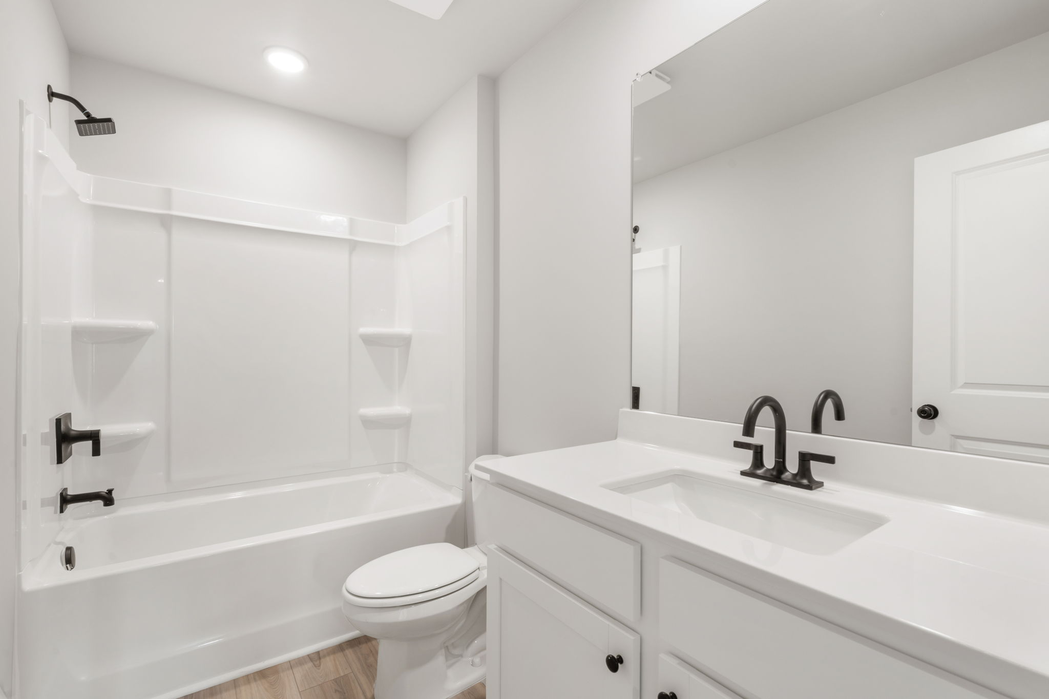 A bathroom with a tub sink and toilet.