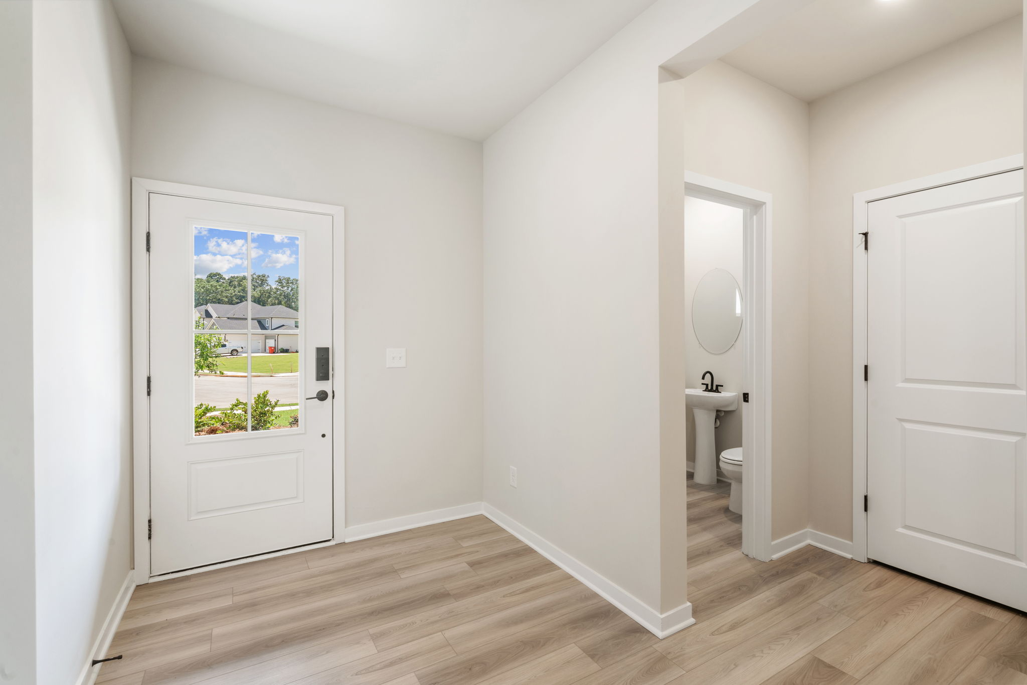 A bathroom with white walls.