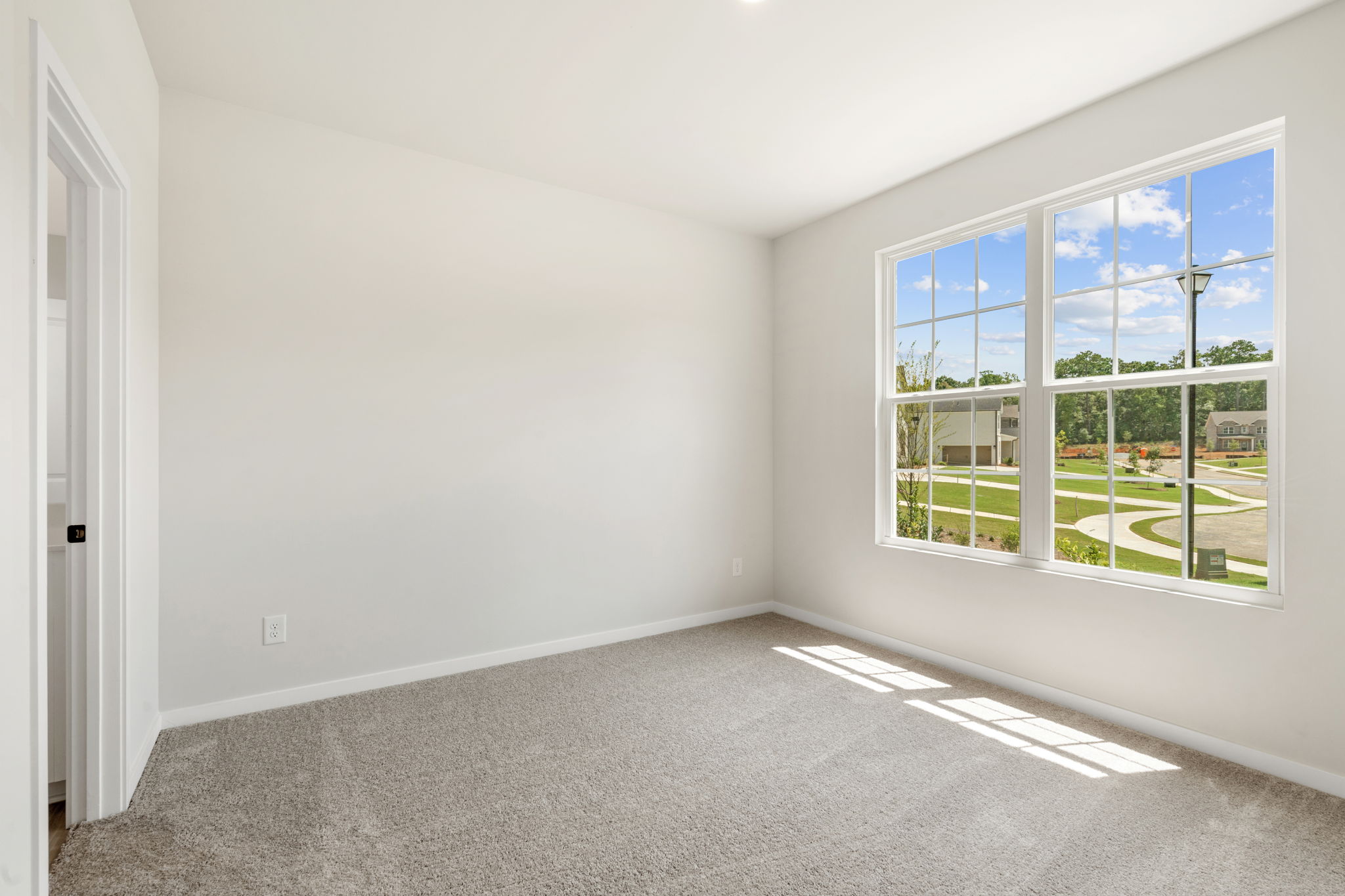 A room with a window and a door.