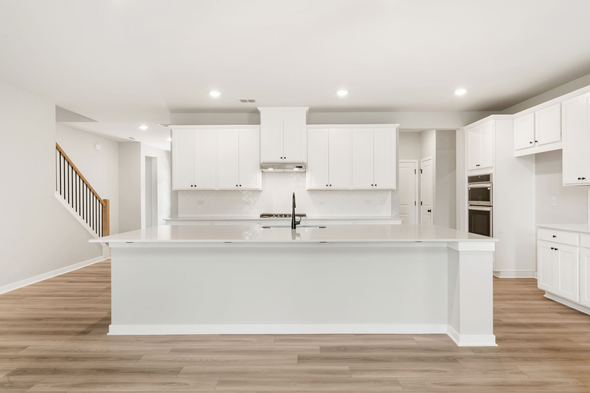 A kitchen with white cabinets.