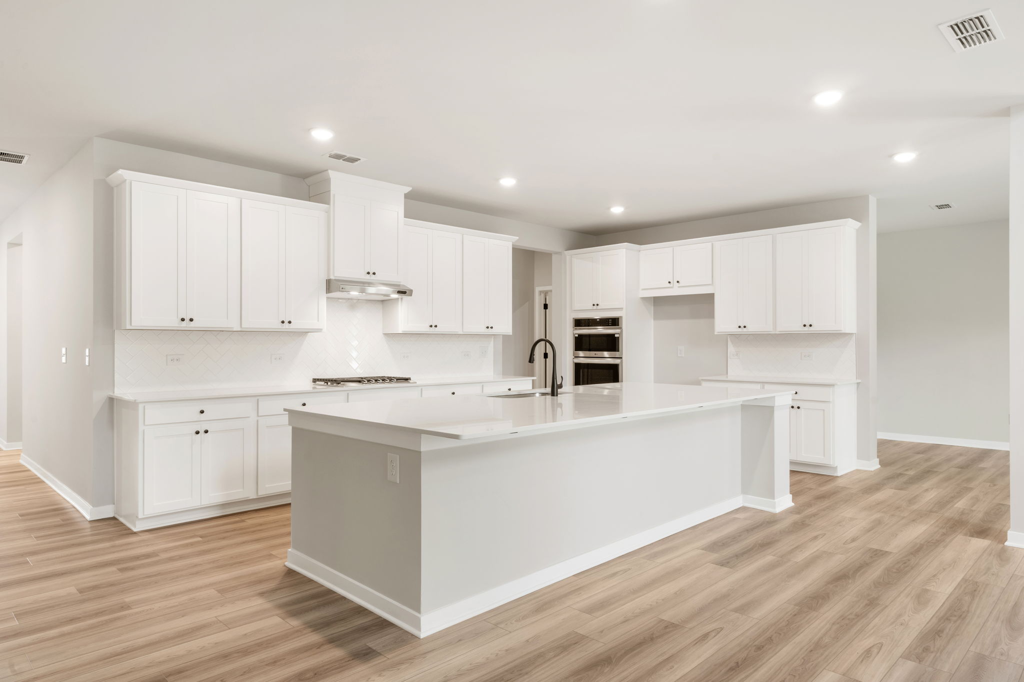 A kitchen with white cabinets.