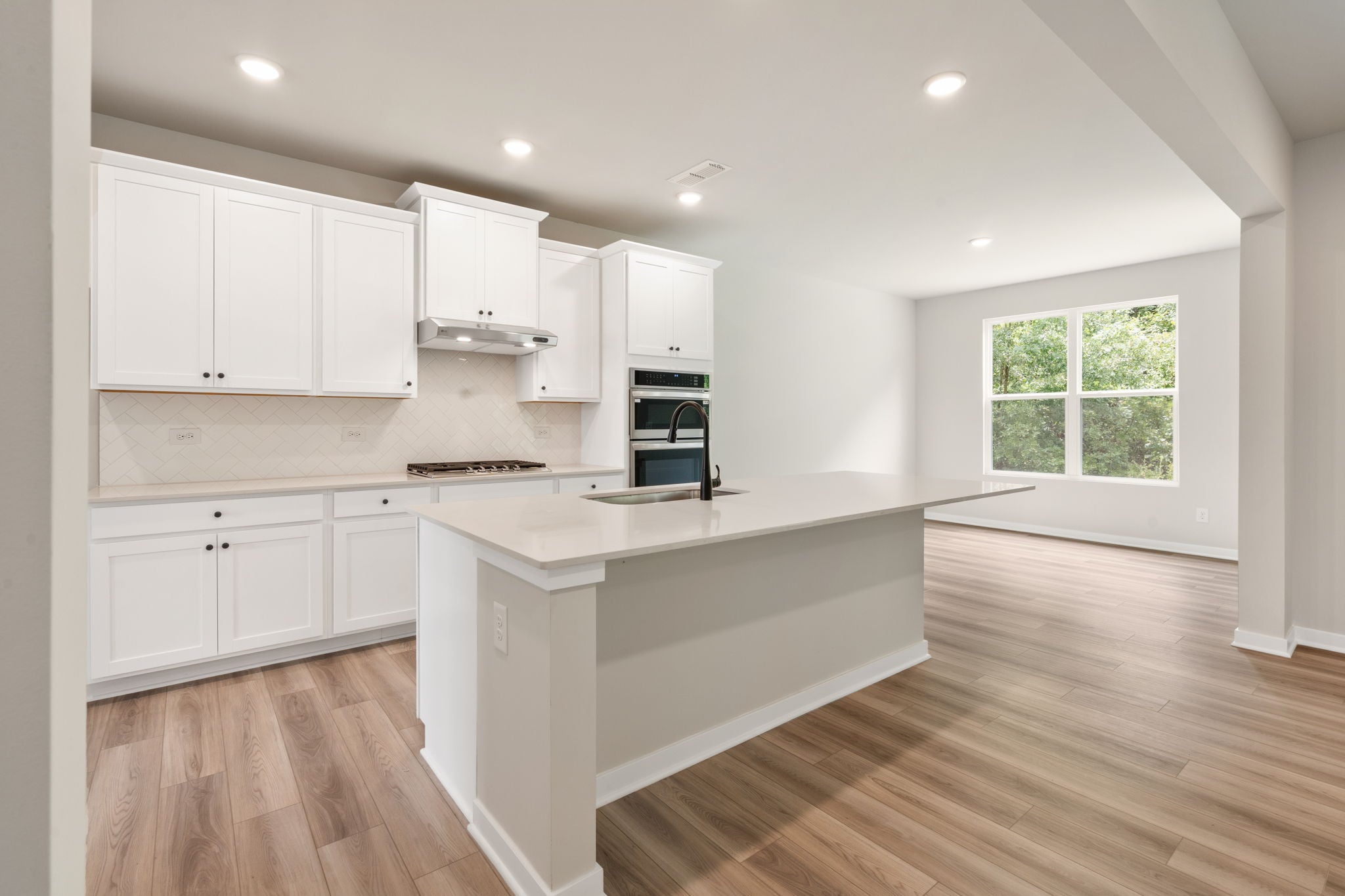 A kitchen with white cabinets.