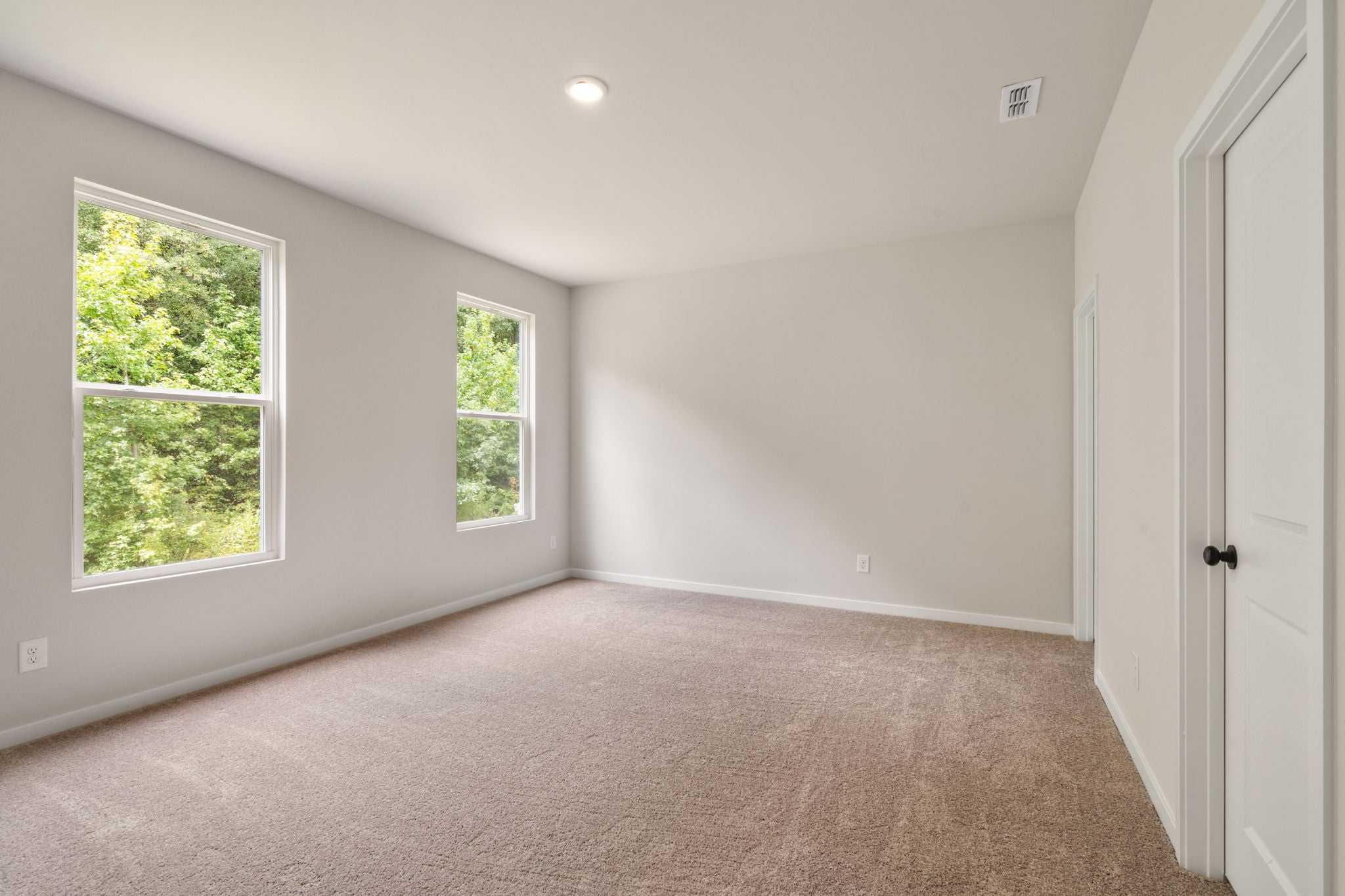 A room with a window and a door.