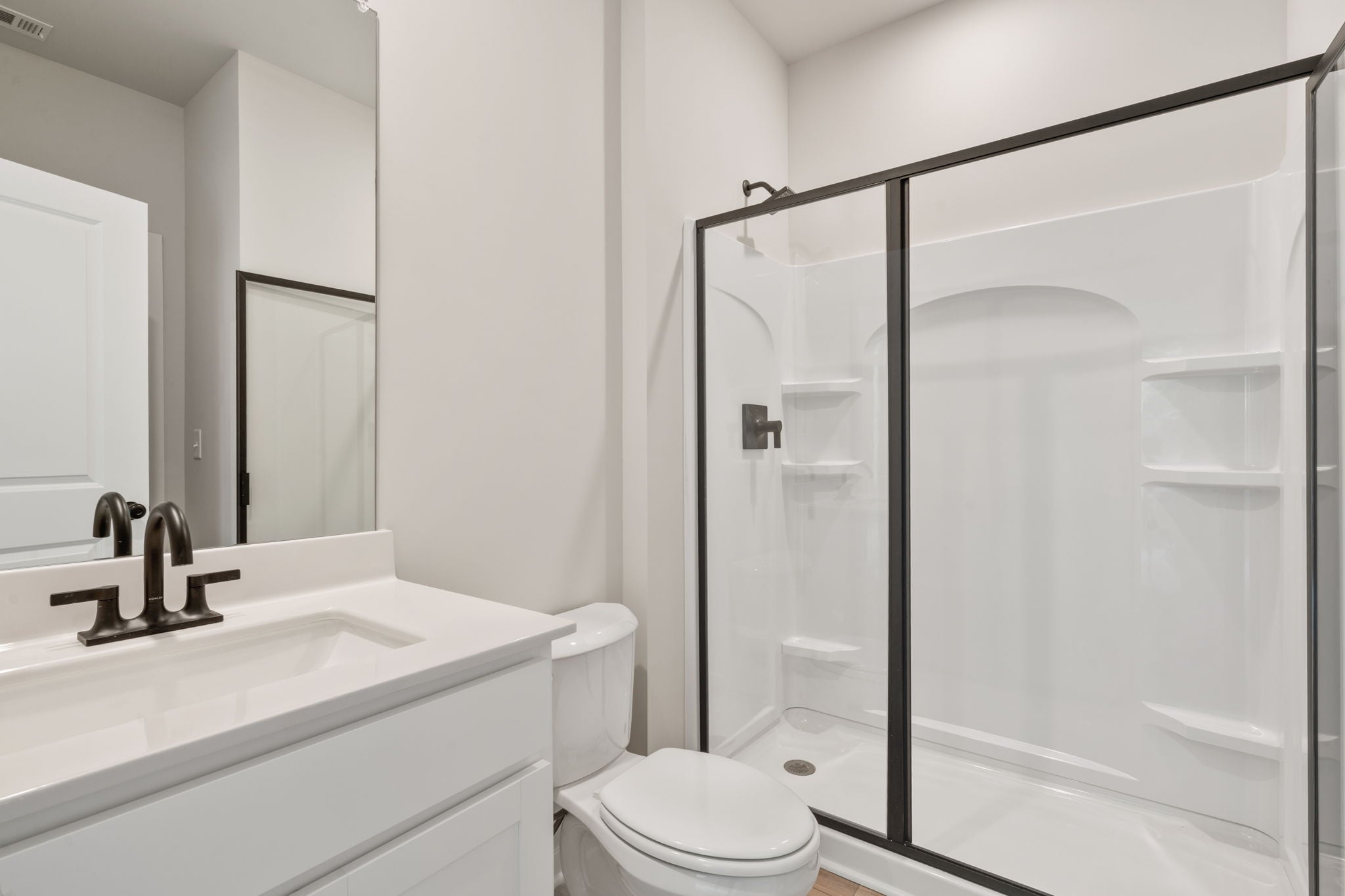 A bathroom with a glass shower.