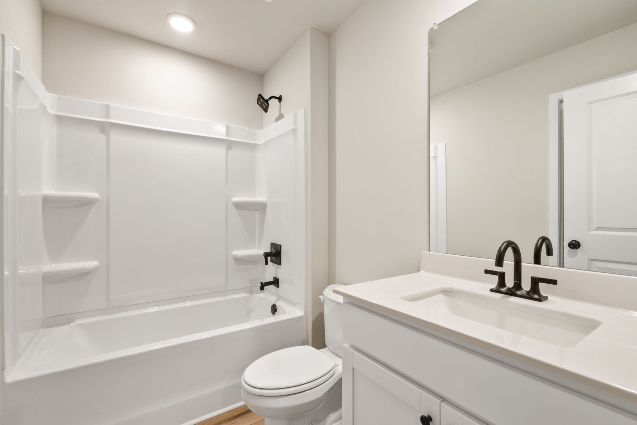 A bathroom with a tub sink and toilet.
