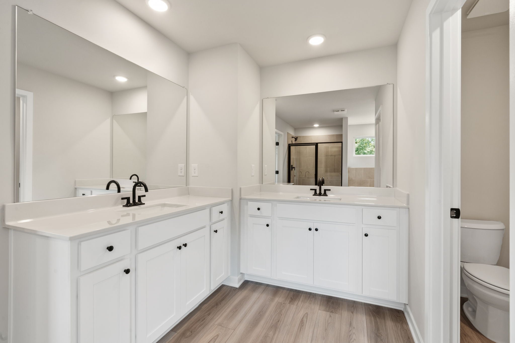 A bathroom with white cabinets.