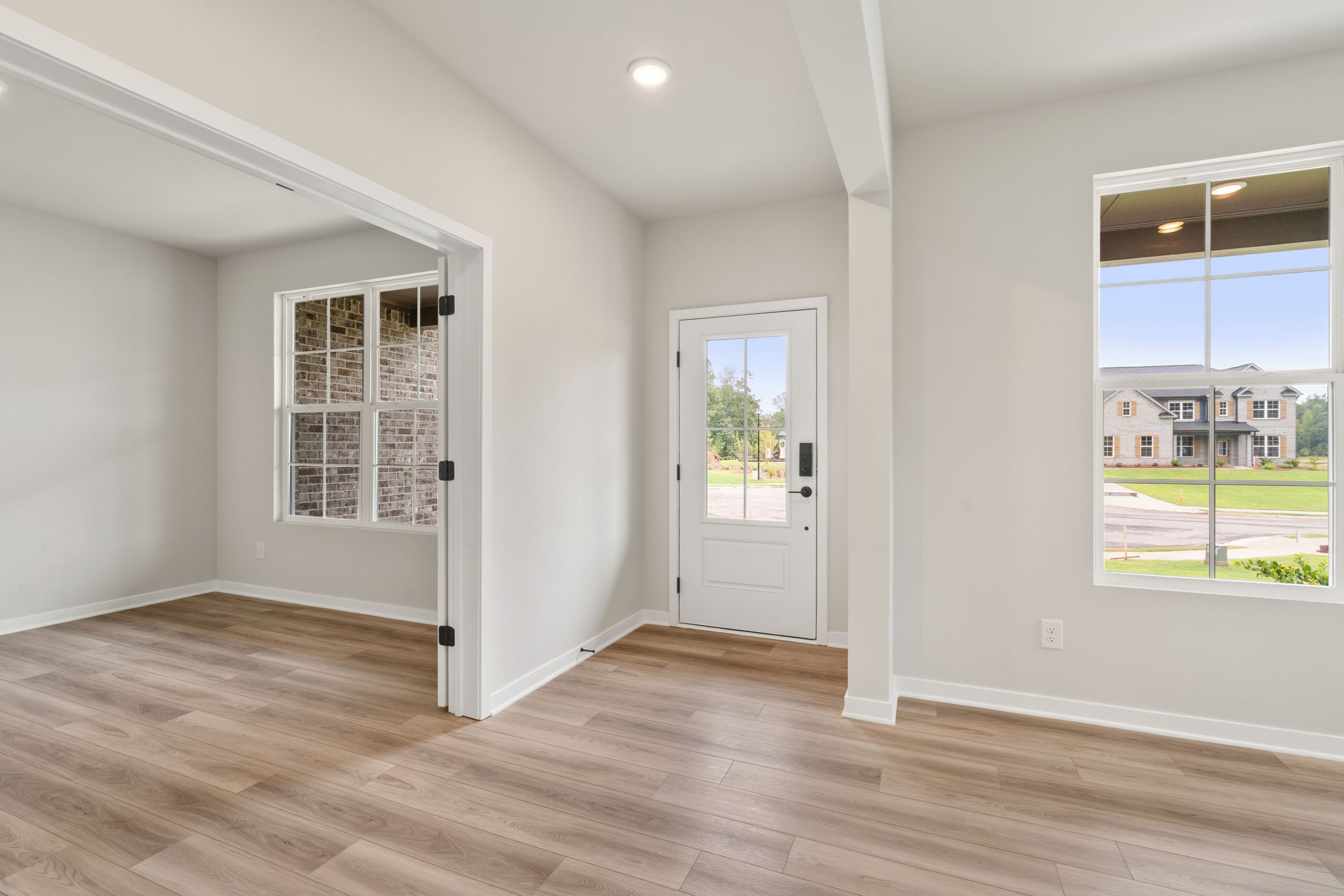 A room with a wood floor and a white door.