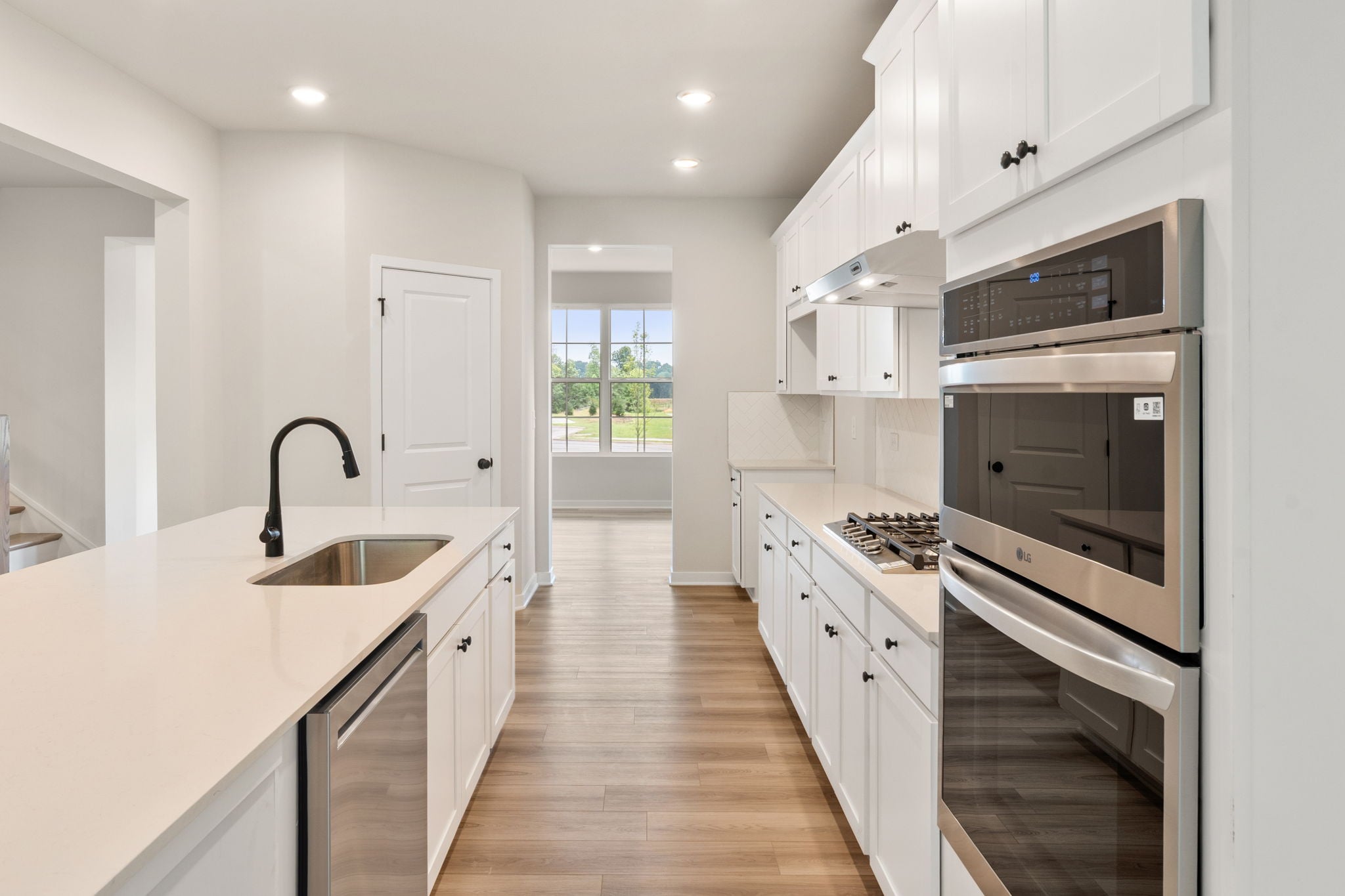 A kitchen with white cabinets.