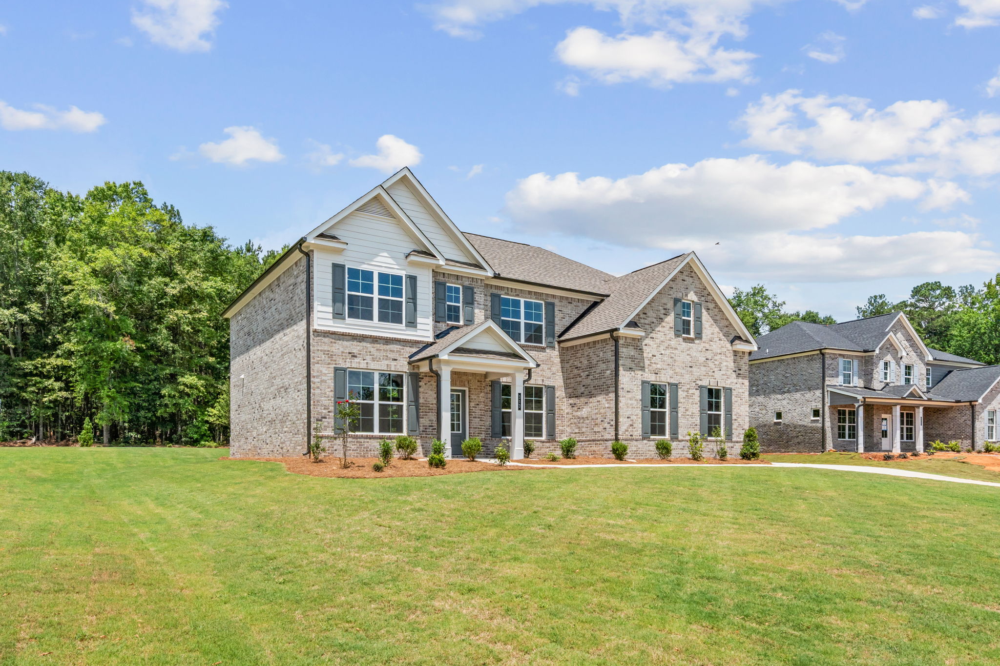A large house with a lawn in front of it.