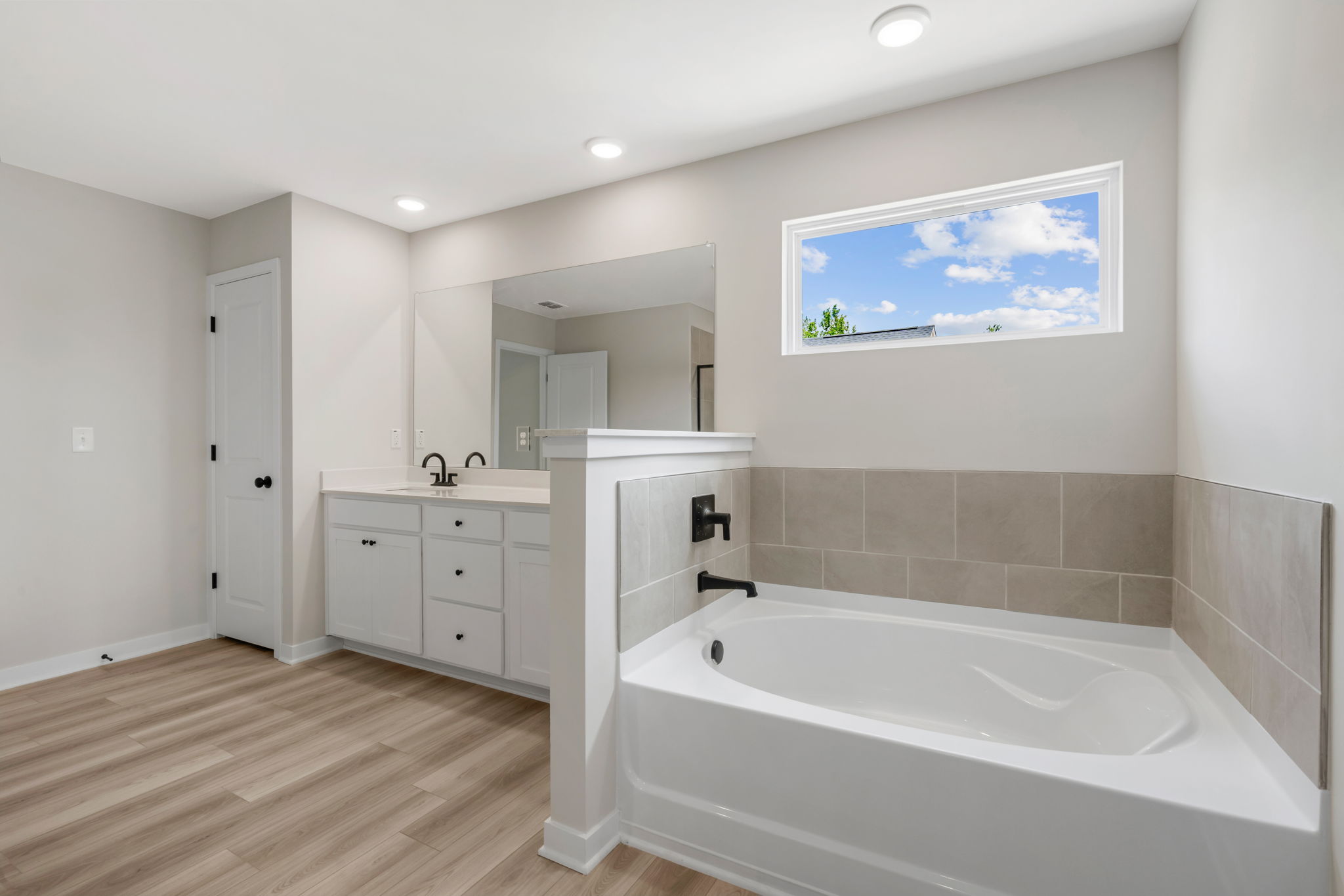 A bathroom with a tub and sink.