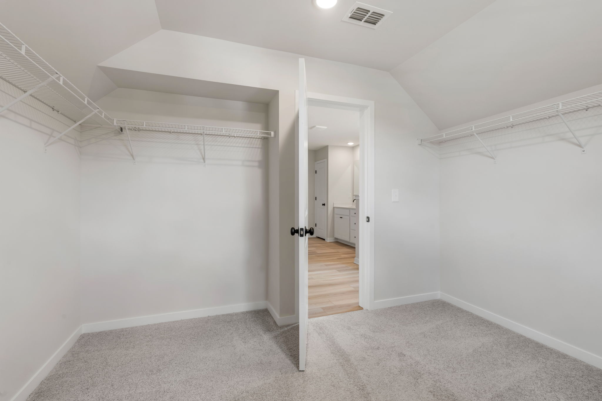 A hallway with white walls.