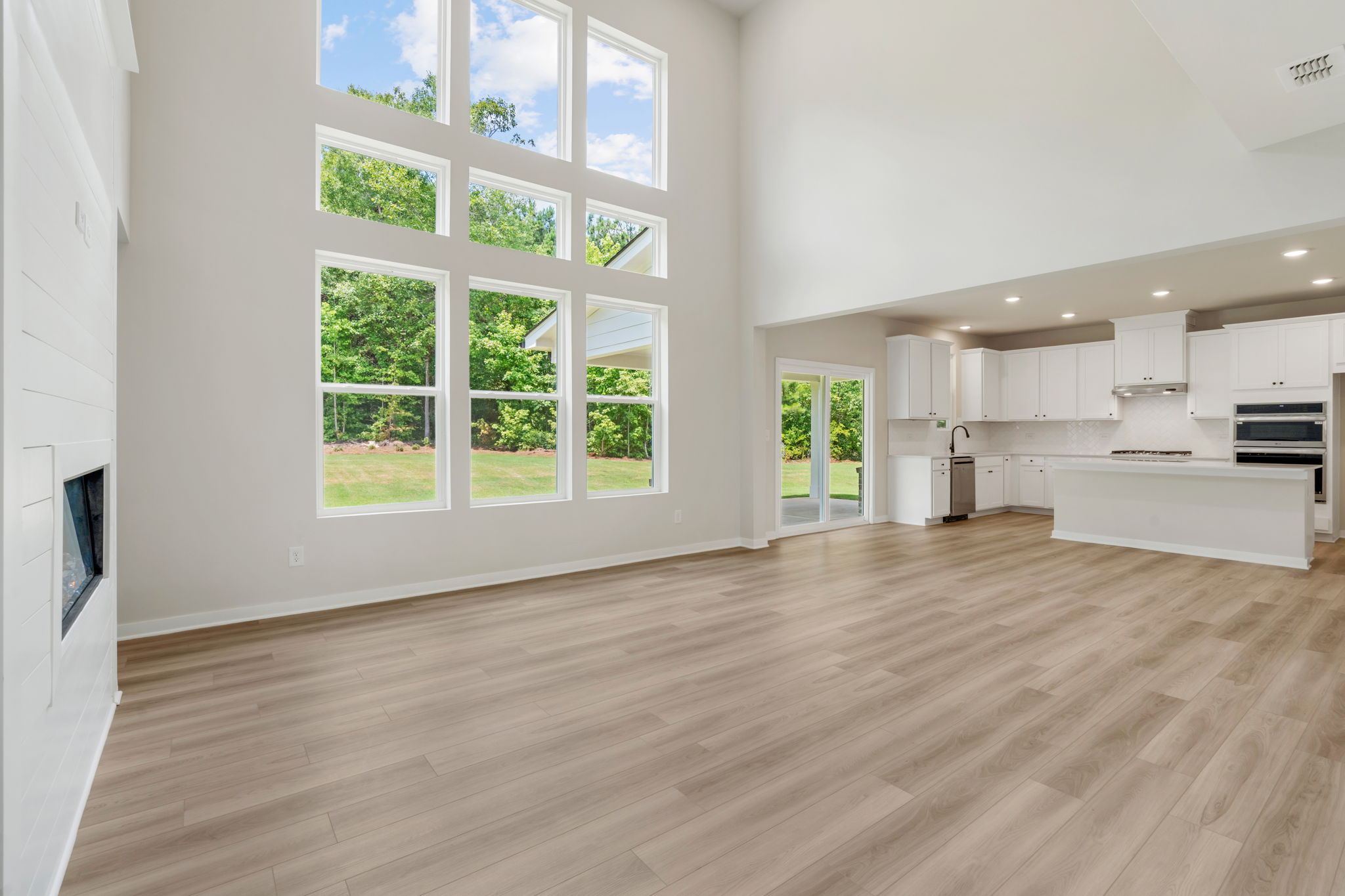 A large empty room with a wood floor and white walls.