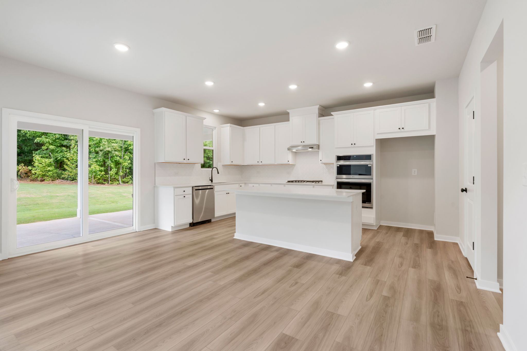A kitchen with white cabinets.