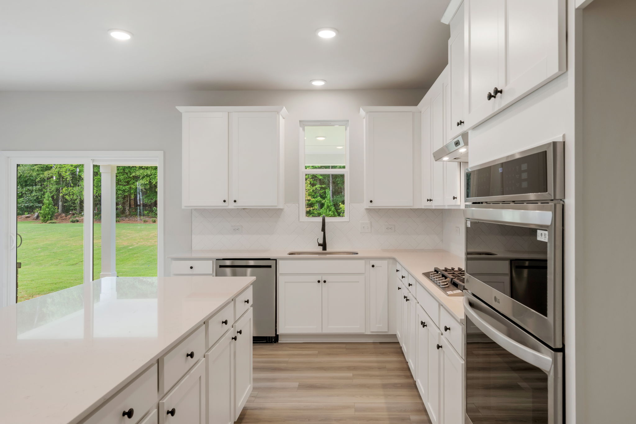 A kitchen with white cabinets.