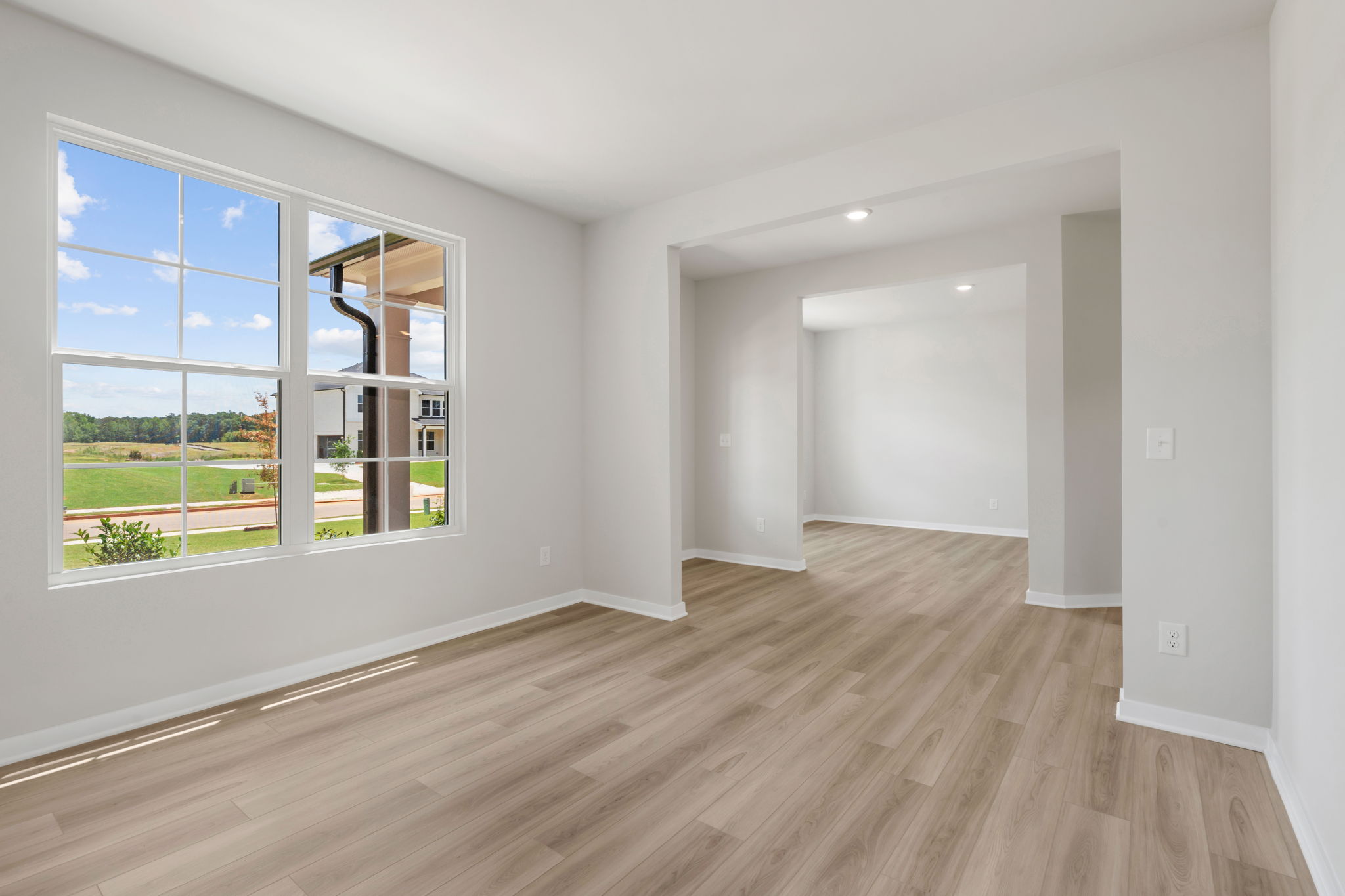 A room with a wood floor and windows.