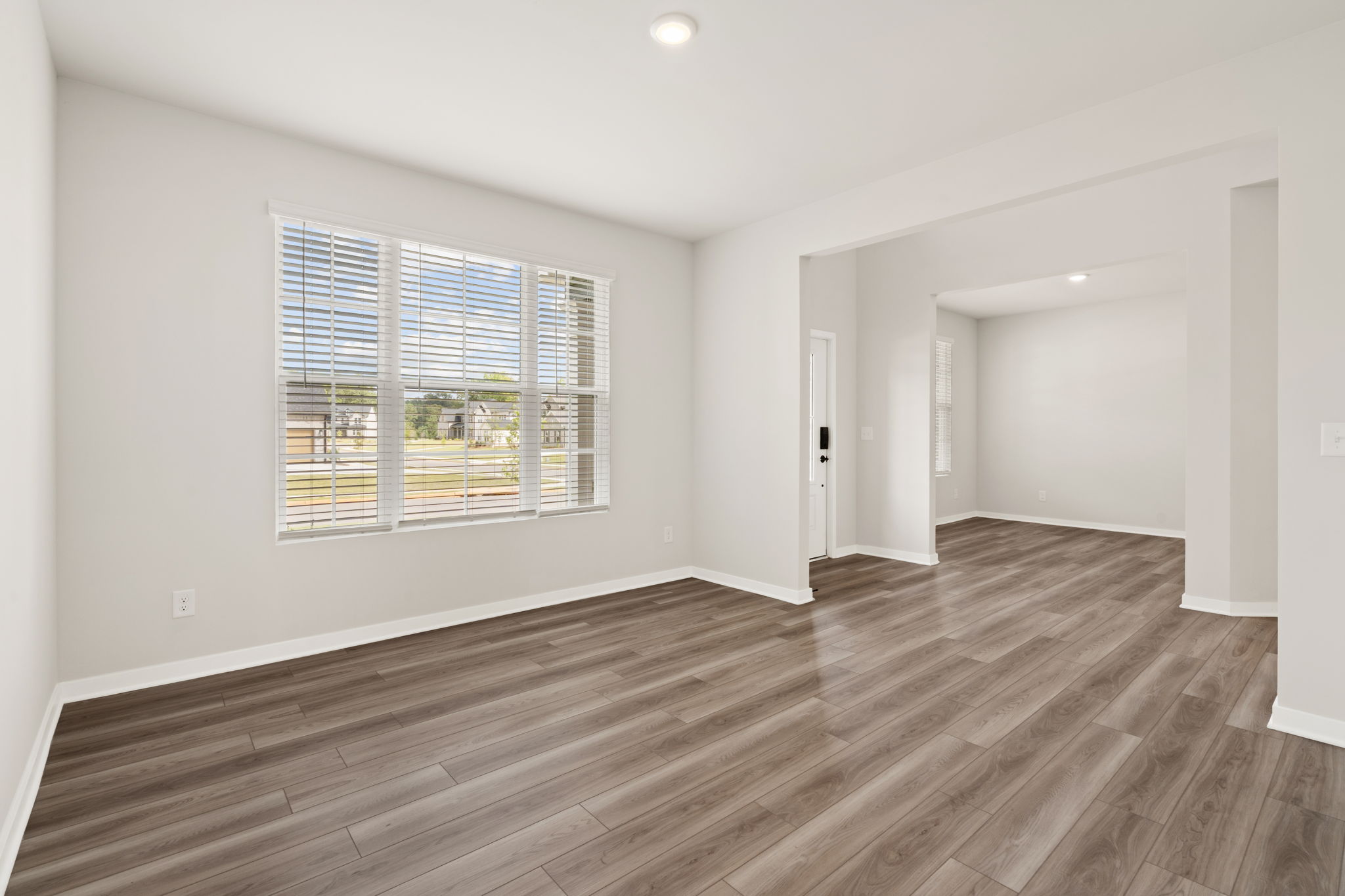 A room with a wood floor and a window.
