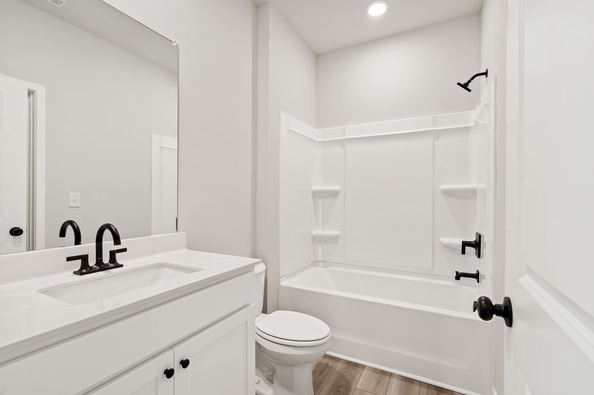 A bathroom with a tub sink and toilet.