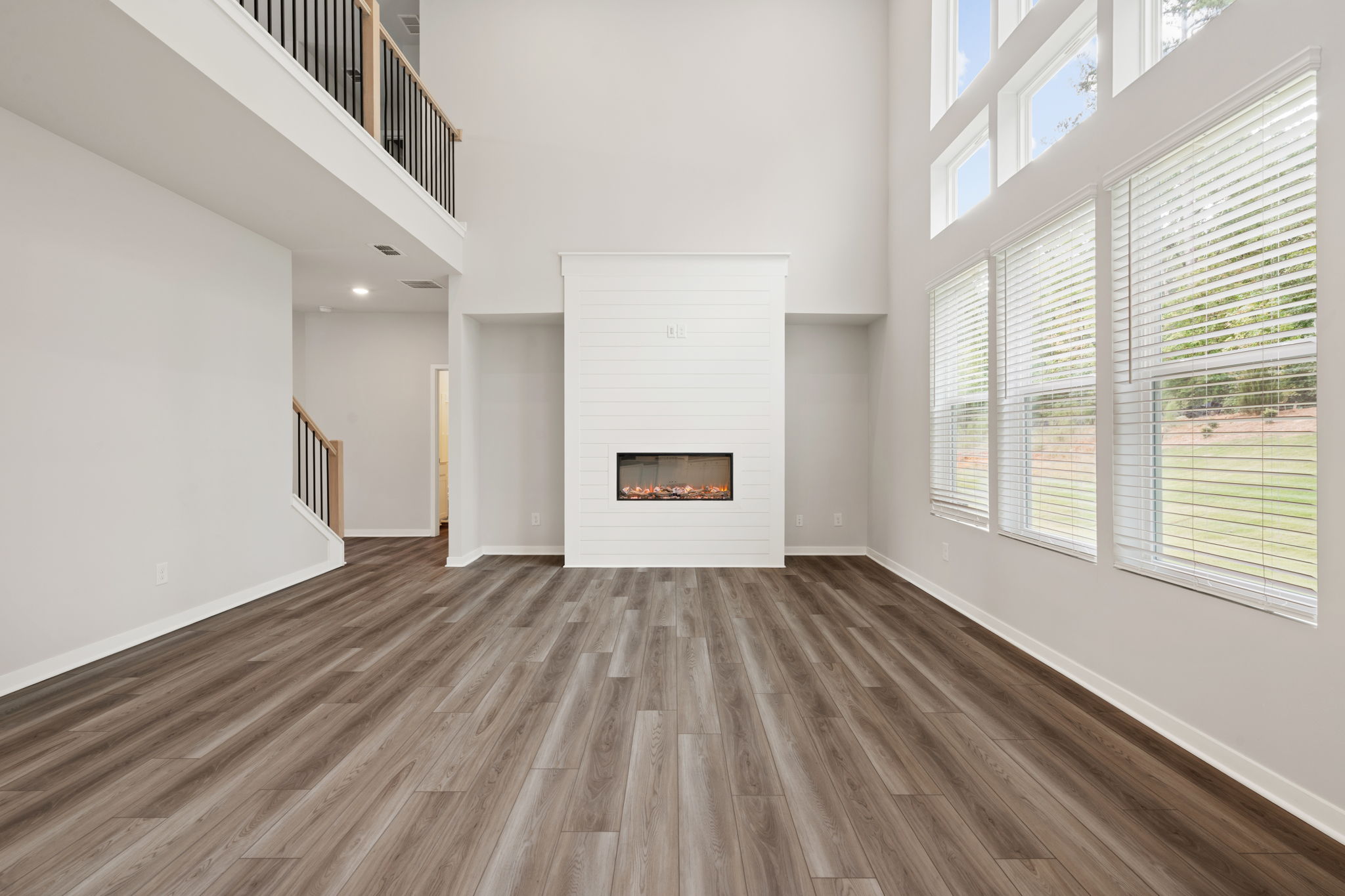 A room with a fireplace and windows.
