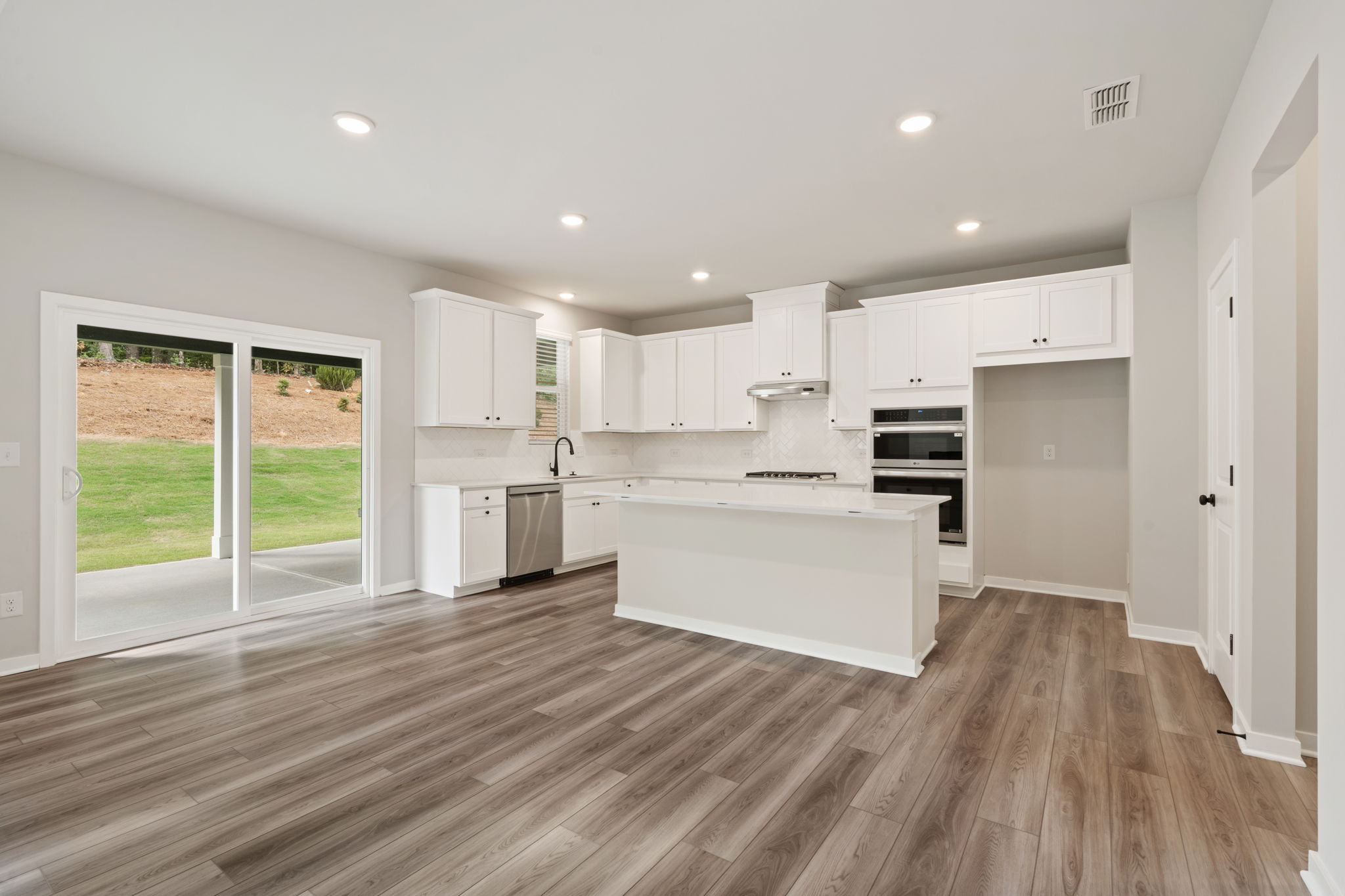 A kitchen with white cabinets.