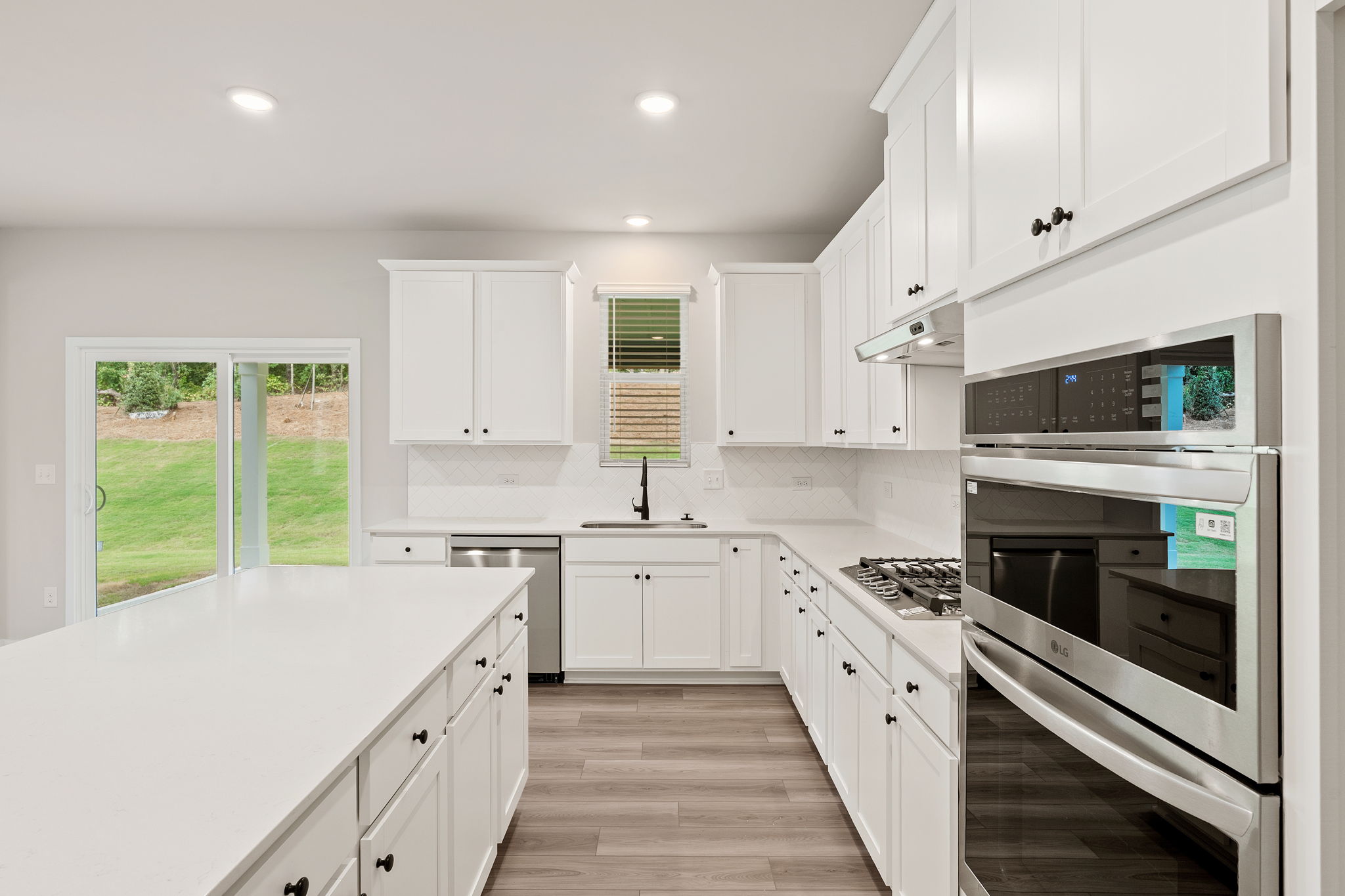 A kitchen with white cabinets.