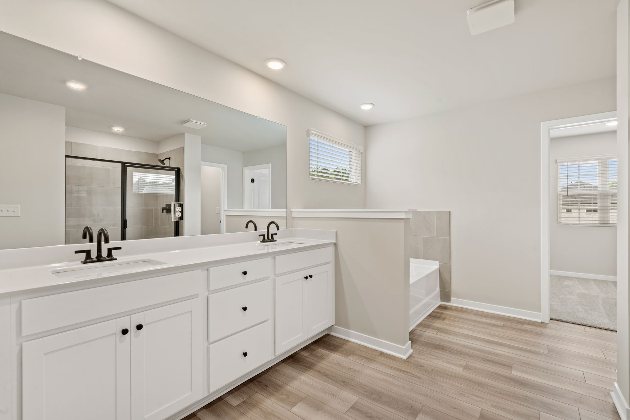 A bathroom with white cabinets.