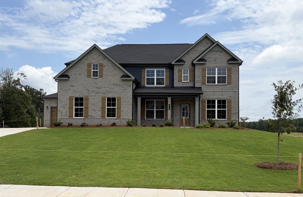 A large house with a lawn.