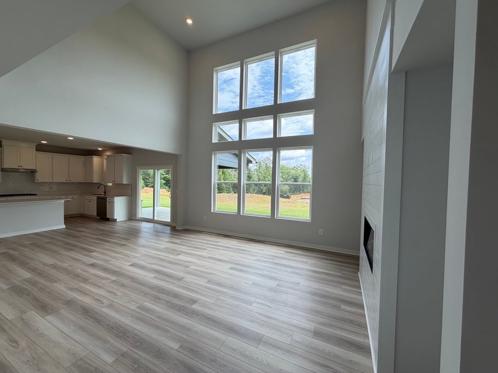 A room with a wood floor and a large window.