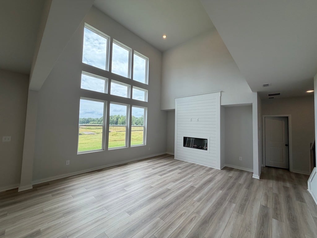 A room with a fireplace and a window.