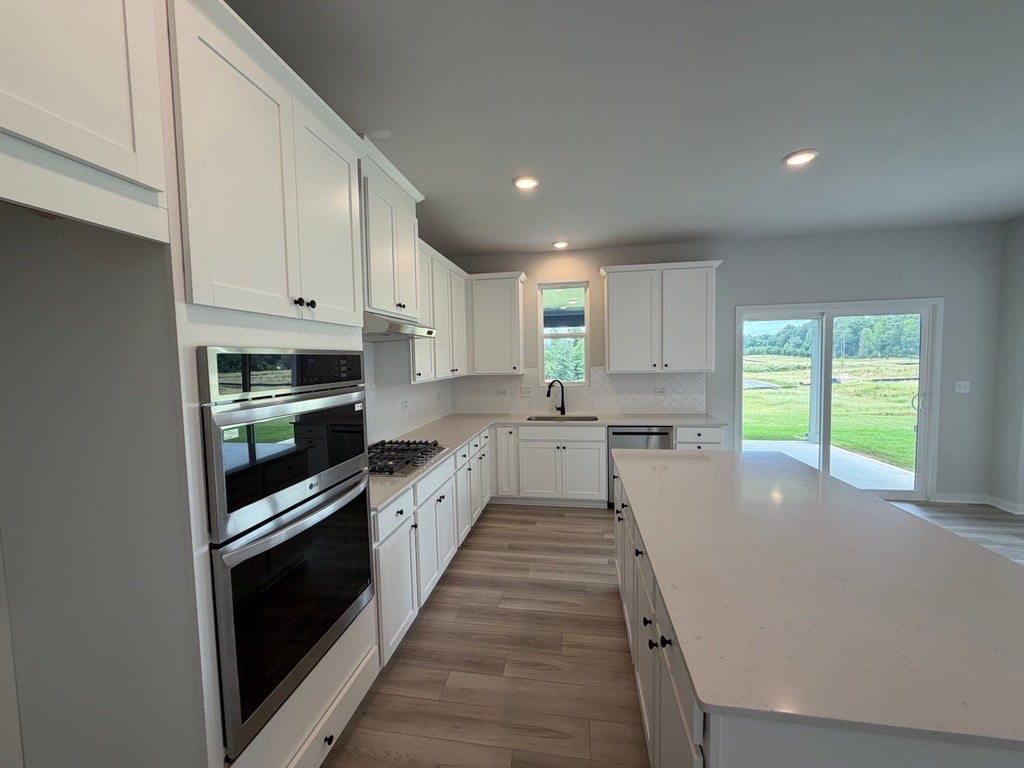 A kitchen with white cabinets.
