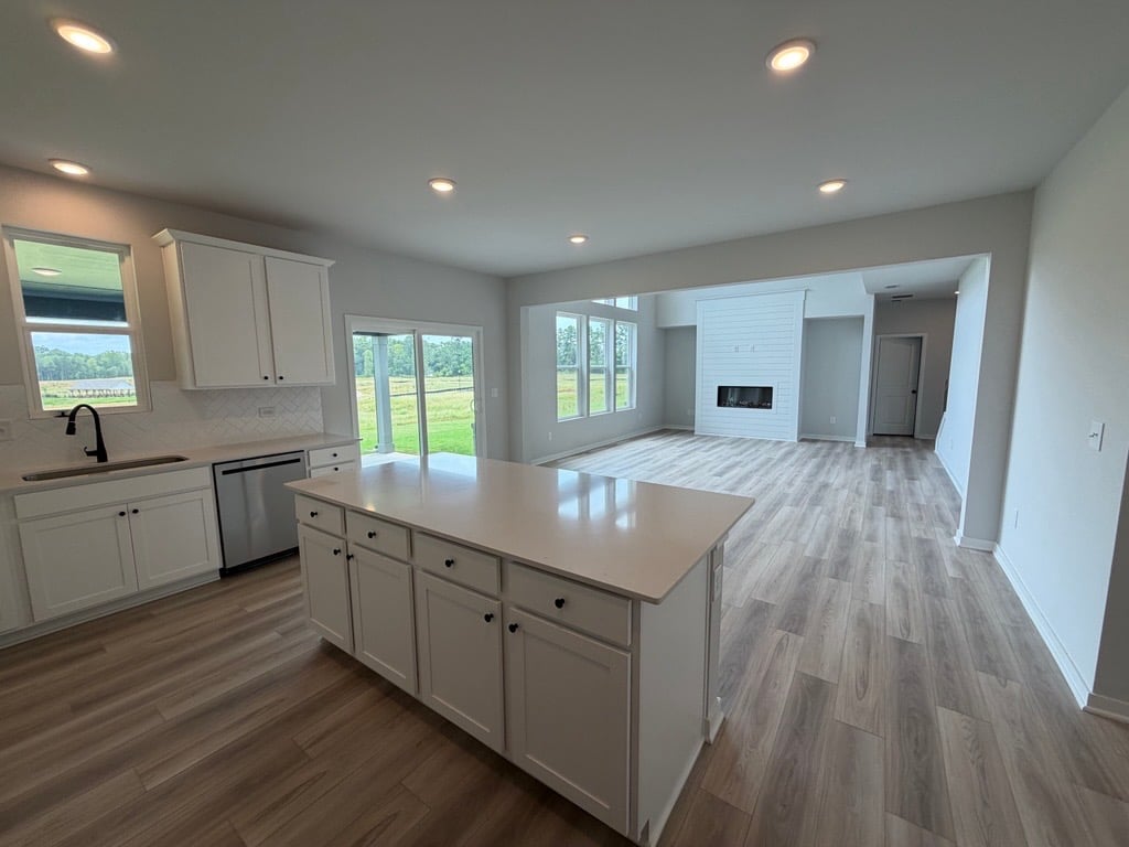 A kitchen with white cabinets.