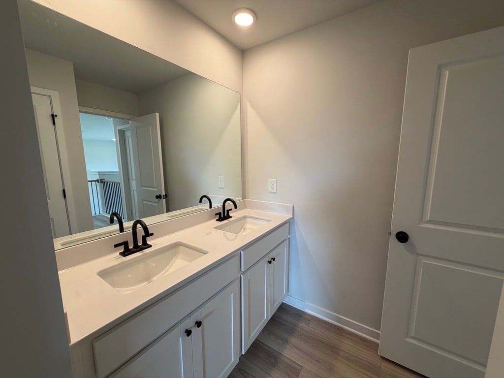 A bathroom with a large mirror.