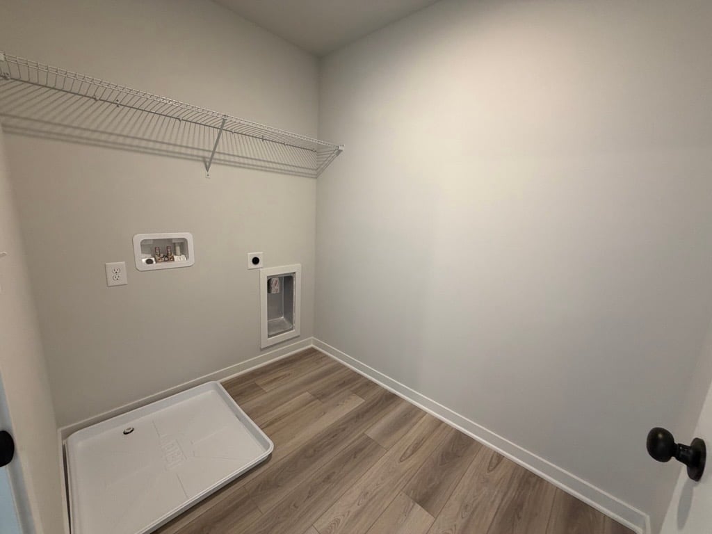 A room with a wood floor and white walls.