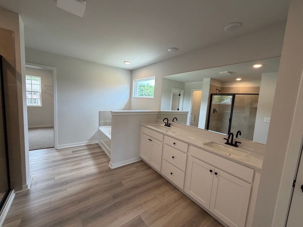 A bathroom with white cabinets.