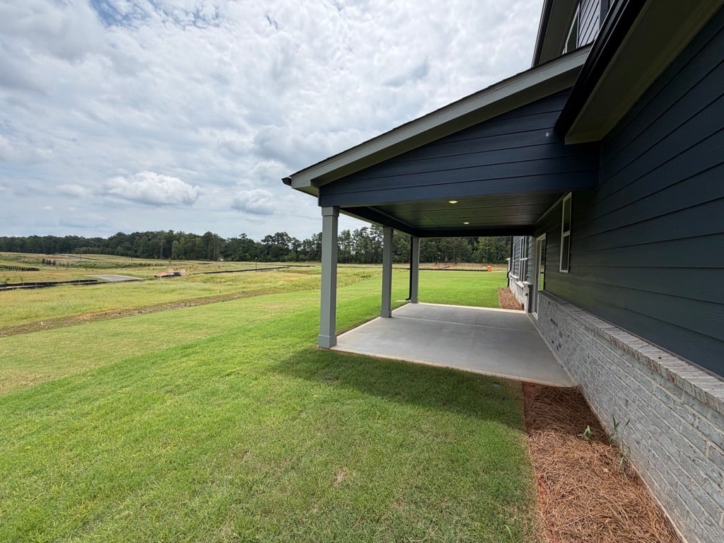 A building with a grass field.