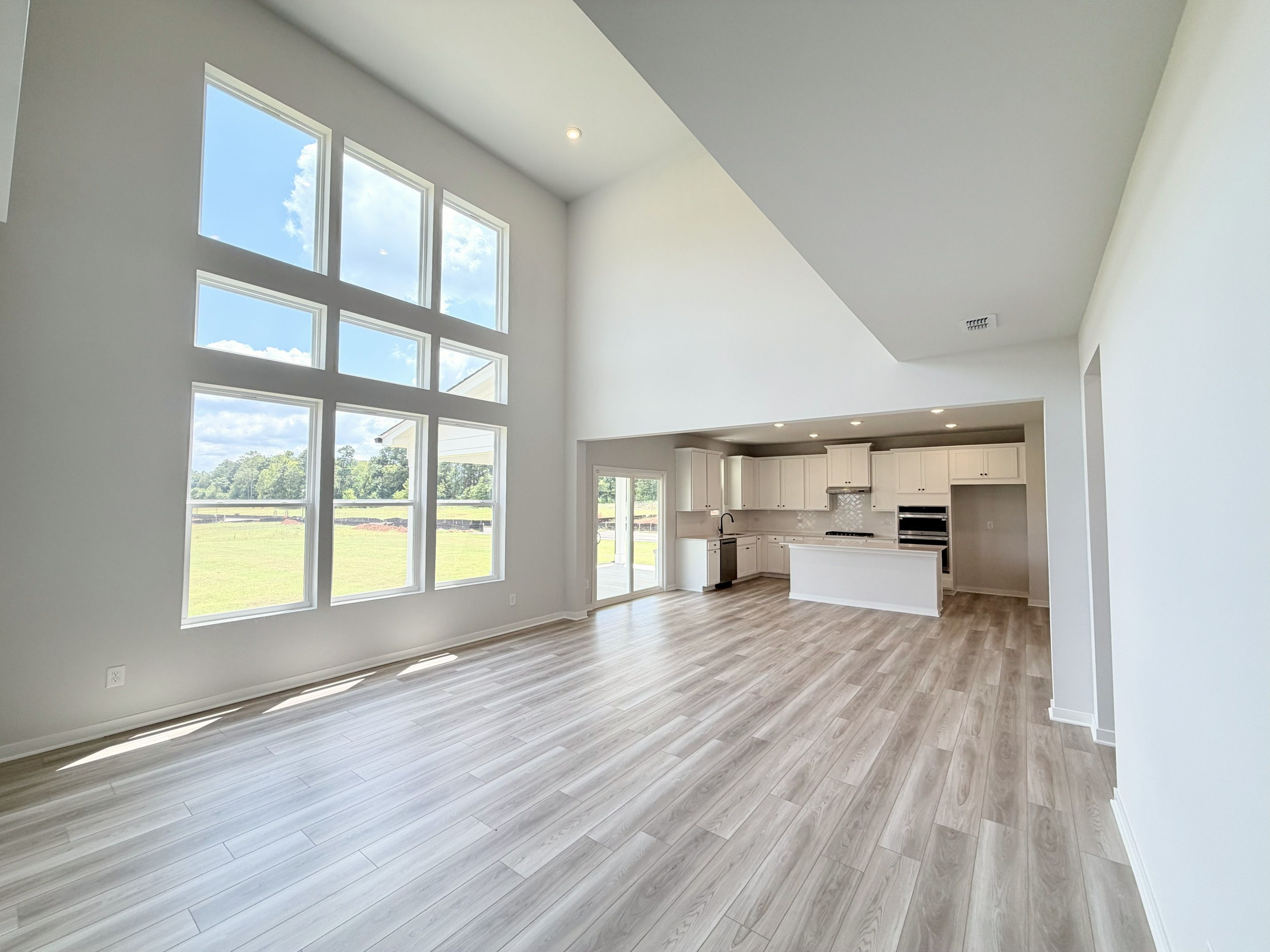 A room with a wood floor and a large window.