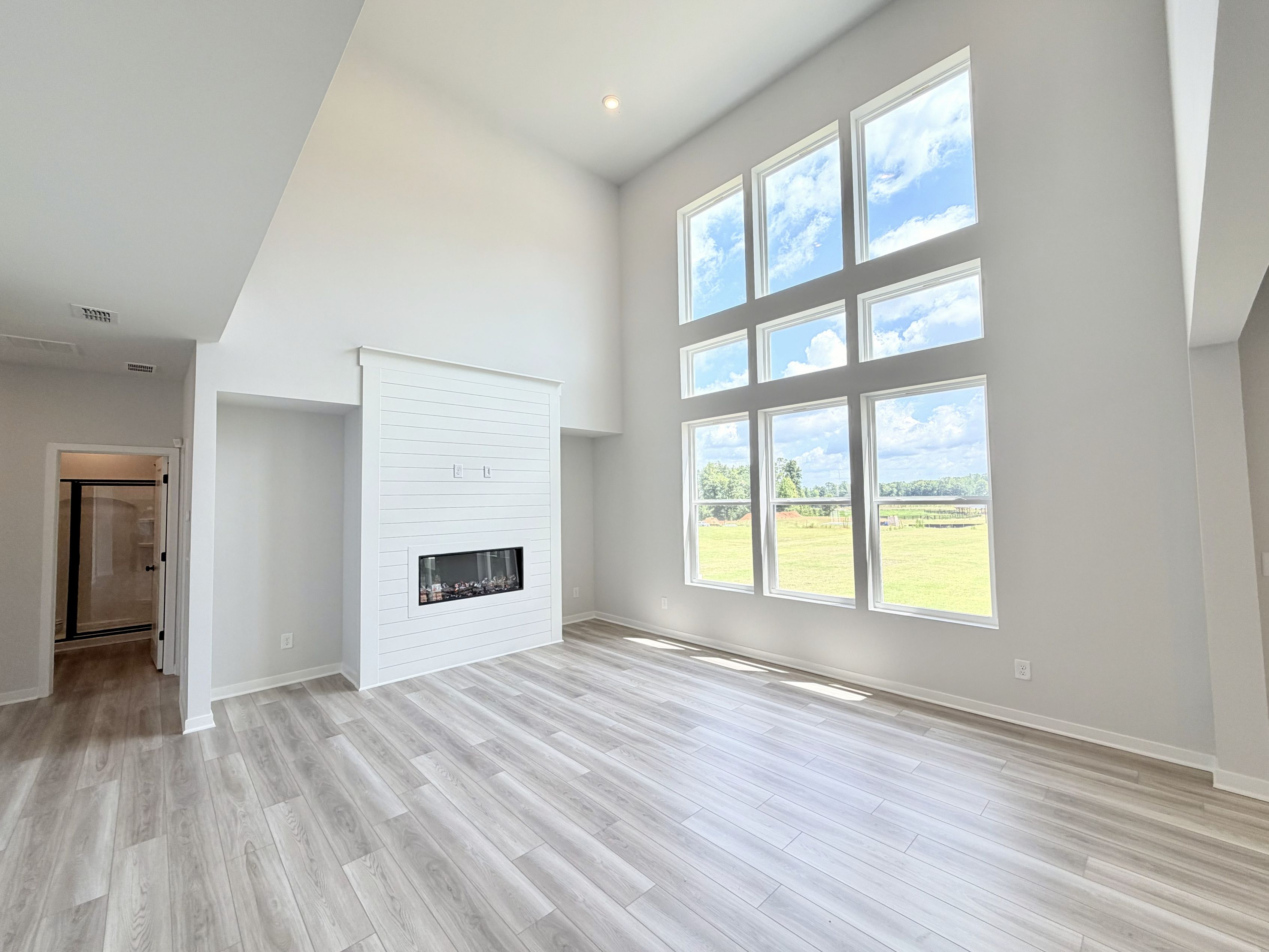 A room with a fireplace and windows.