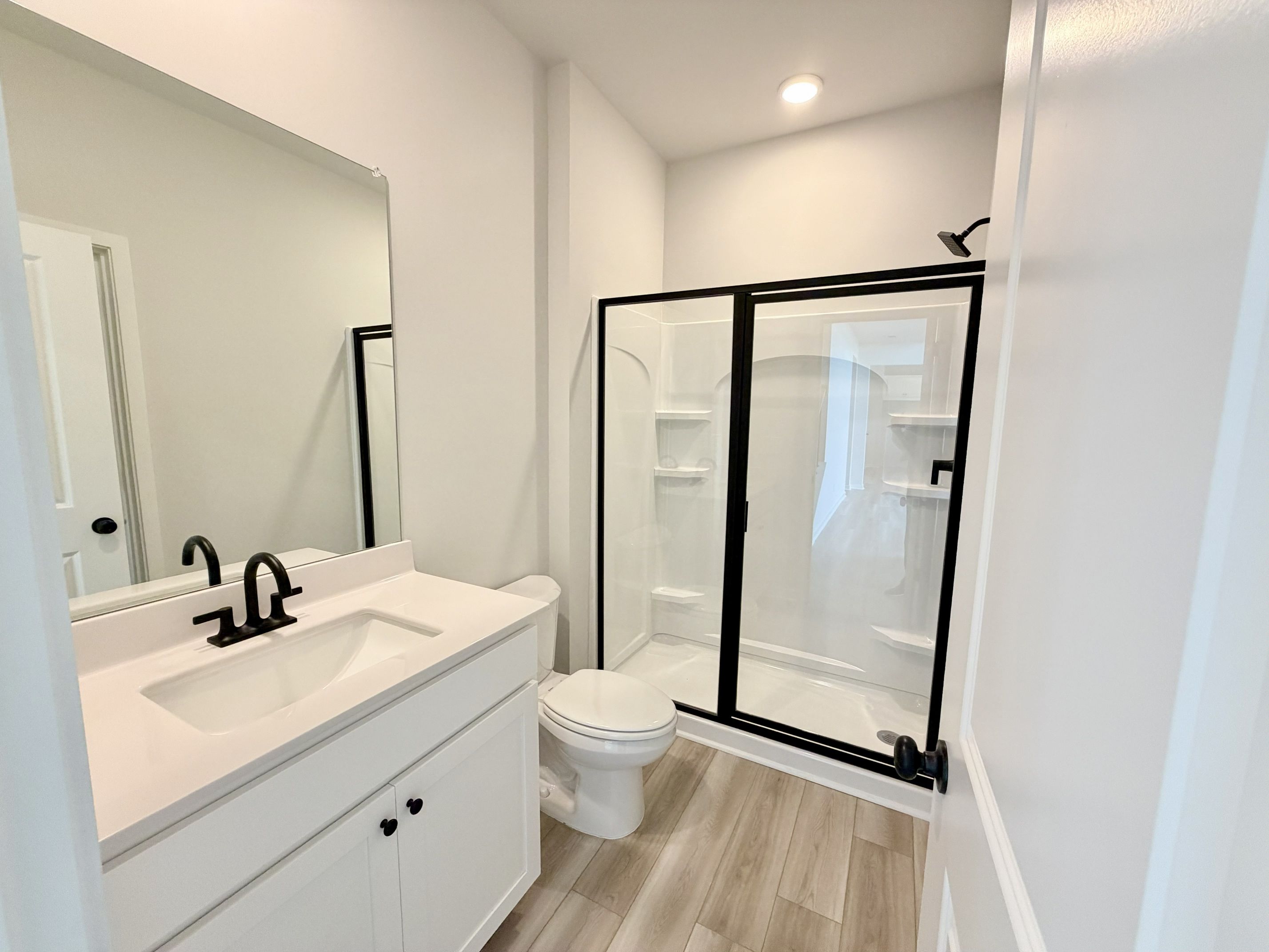 A bathroom with a glass shower.