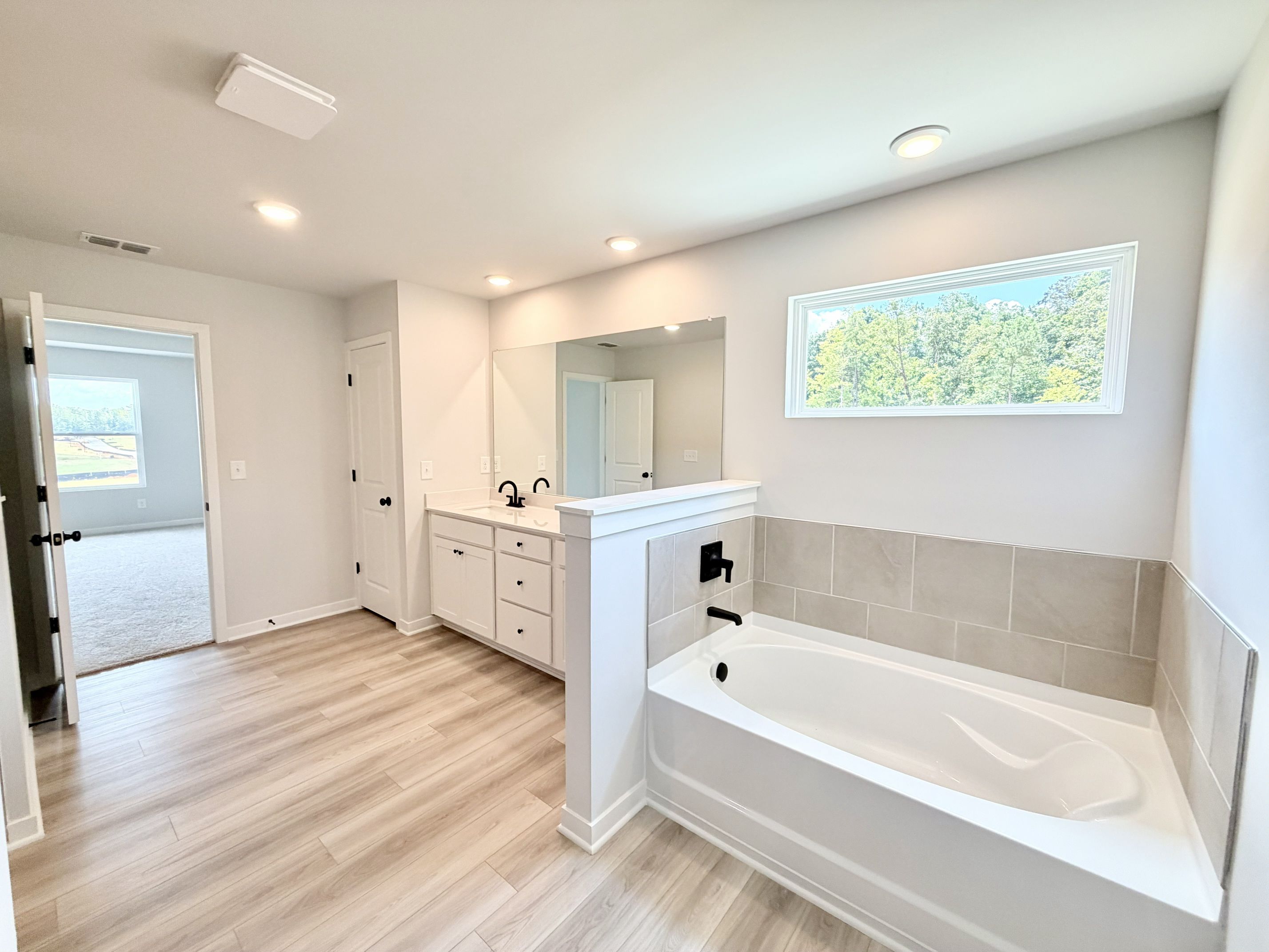 A bathroom with a tub and sink.