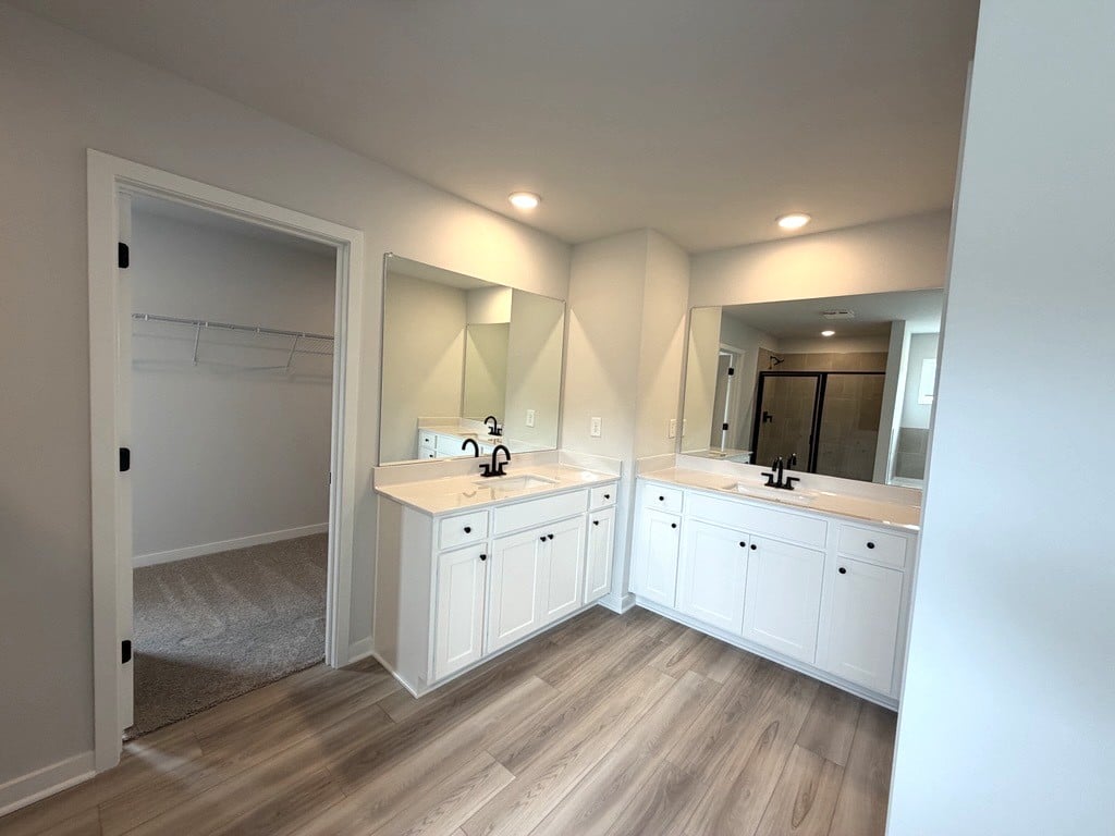 A bathroom with a wood floor.