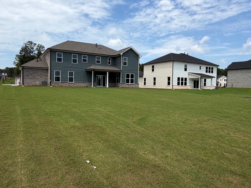 A large house with a lawn in front of it.