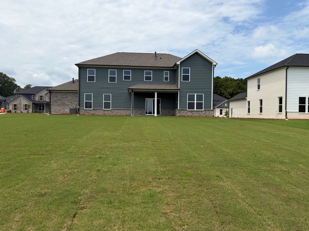 A house with a lawn in front of it.