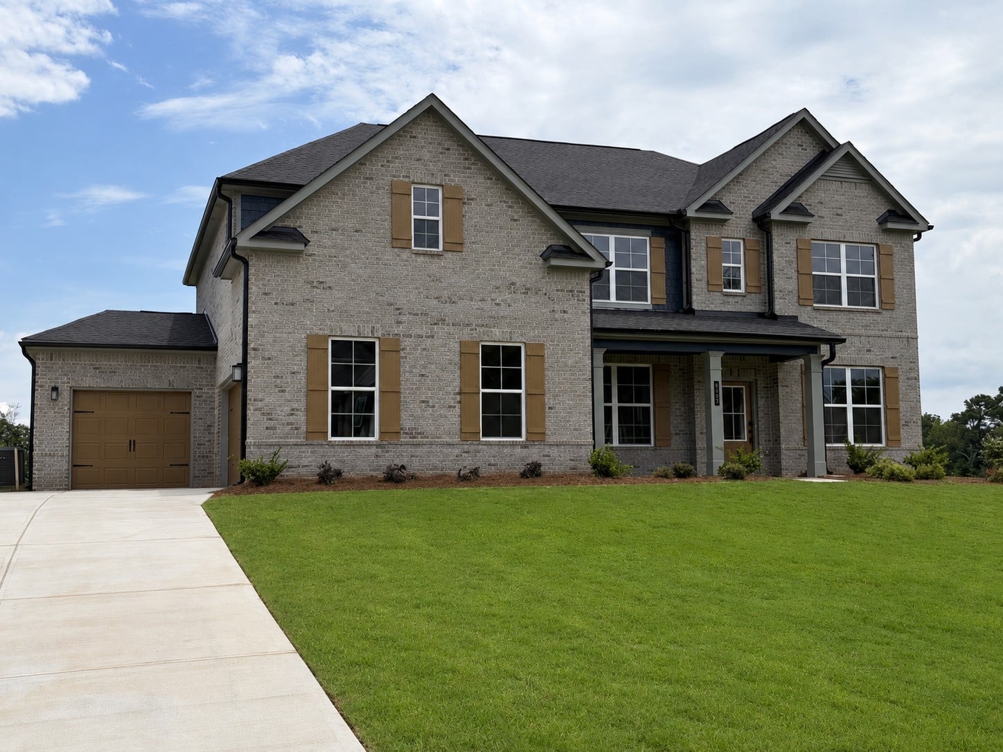 A large house with a lawn.