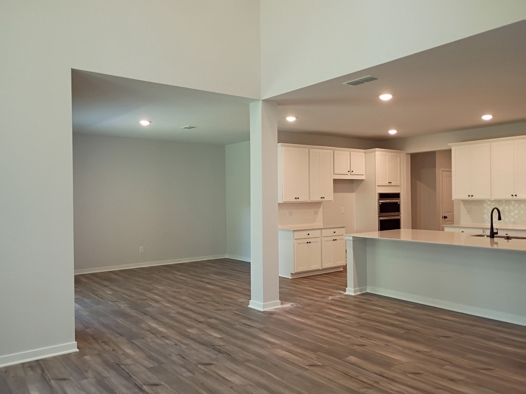 A kitchen with white cabinets.