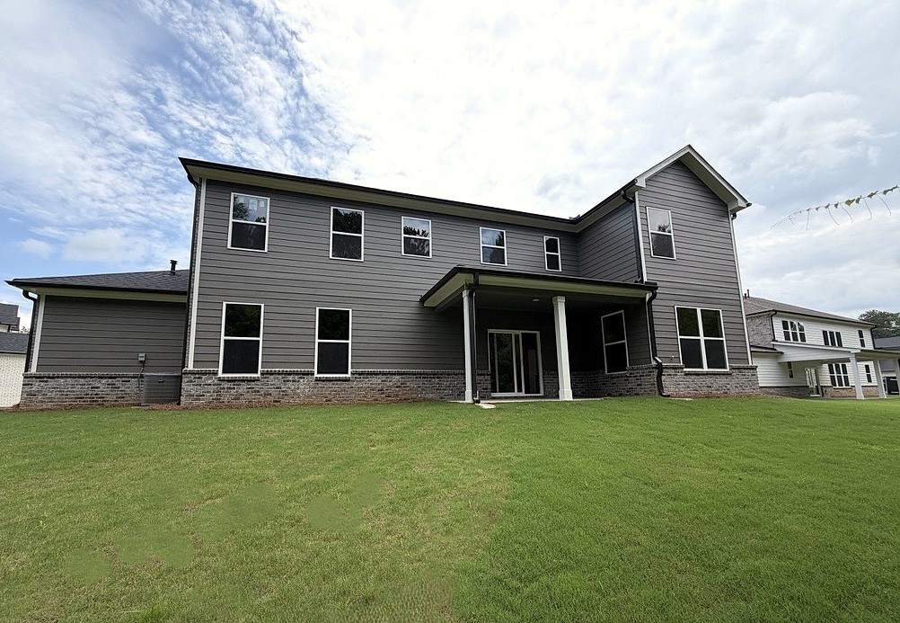 A house with a lawn in front of it.
