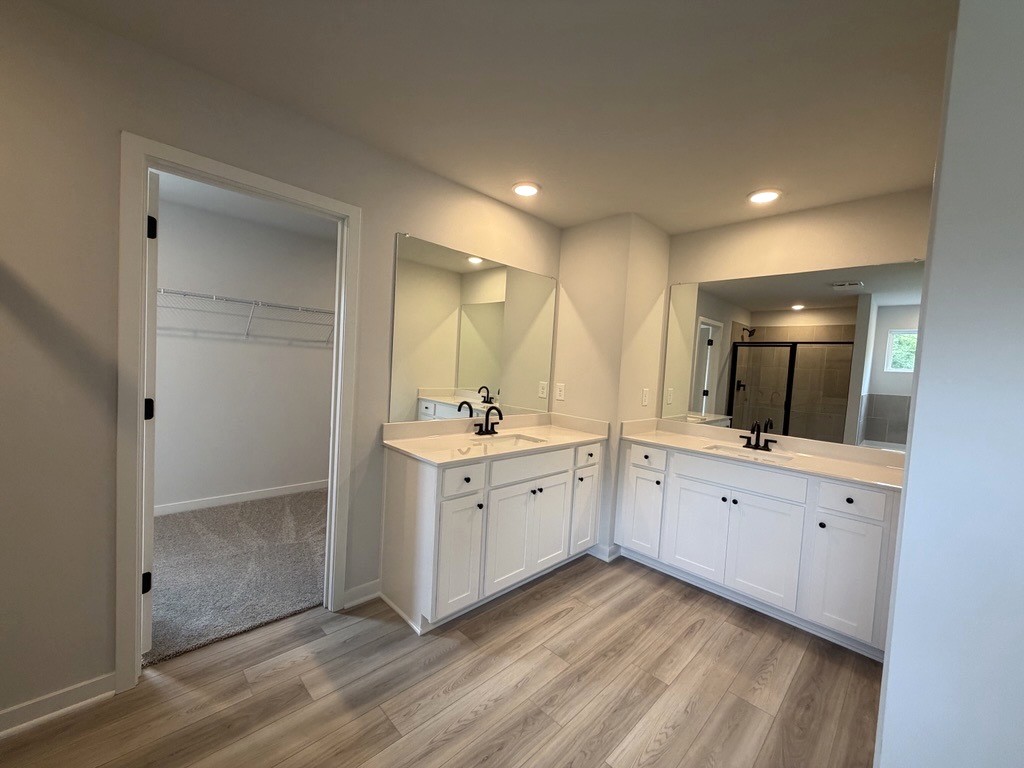 A bathroom with white cabinets.